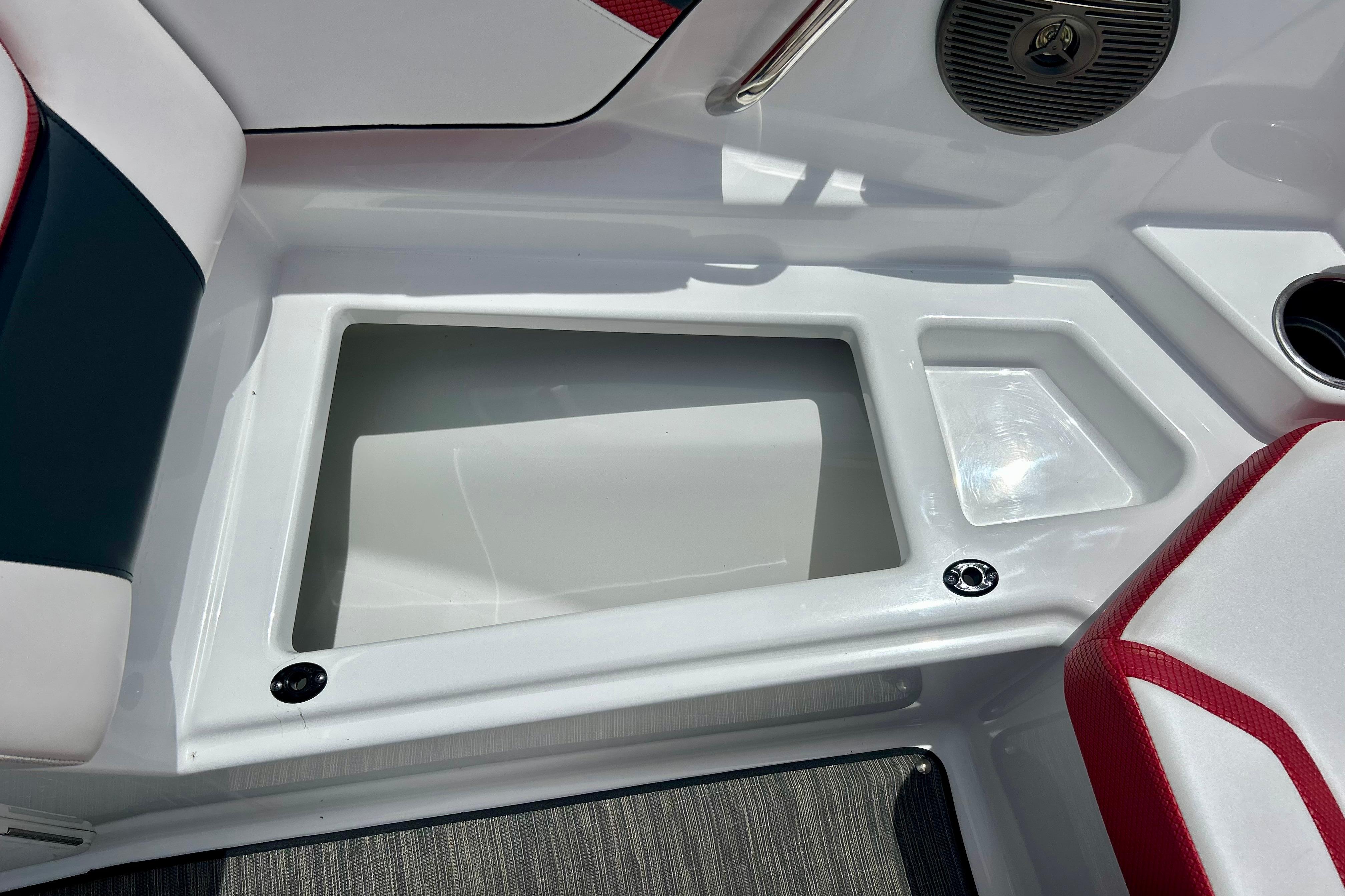 Interior view of a 2021 Scarab 195 ID boat, featuring seating and storage compartments.