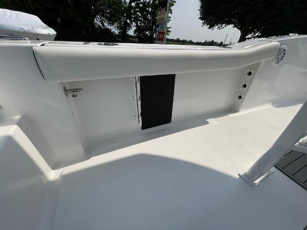 2025 Tidewater 232 CC Adventure boat interior, featuring sleek white seating and storage compartments.