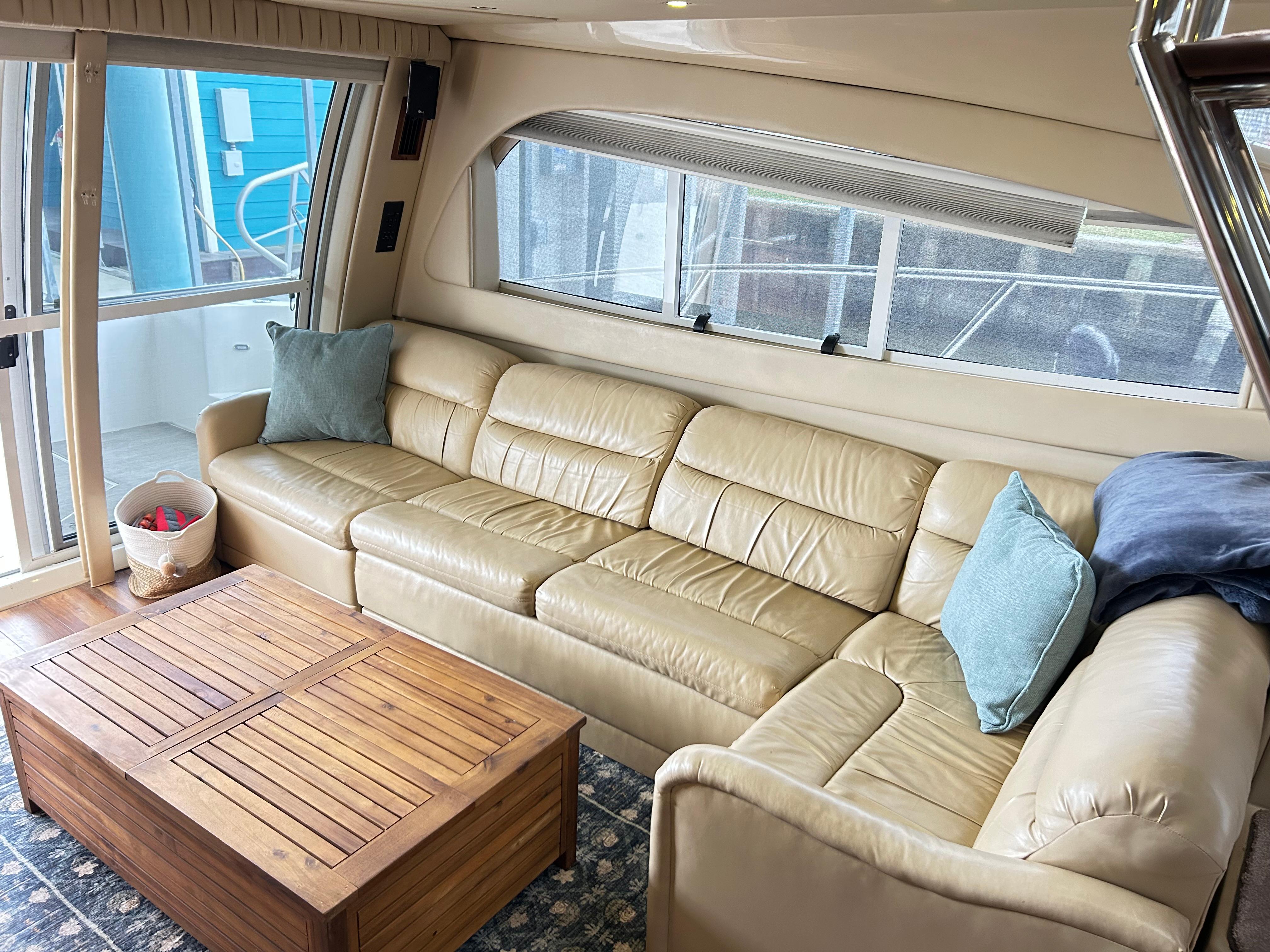 Luxurious interior of 2004 Cruisers Yachts 5000 Sedan Sport with beige leather seating.