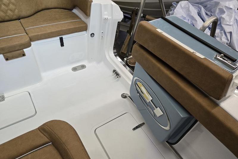 2026 Sea Hunt Ultra 275 Coffin Box interior with brown seating and storage compartments.