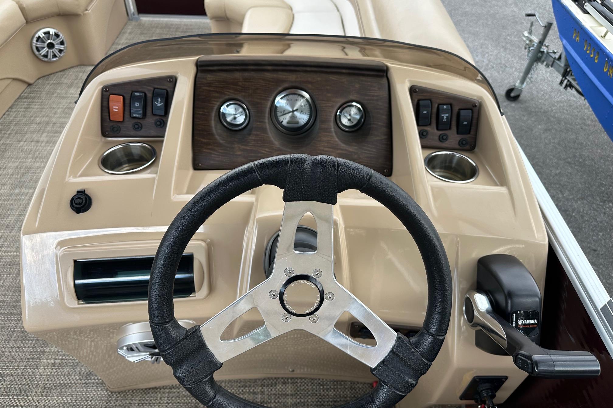 Steering console of a 2016 Bennington 24 SCWX pontoon boat with controls and gauges.