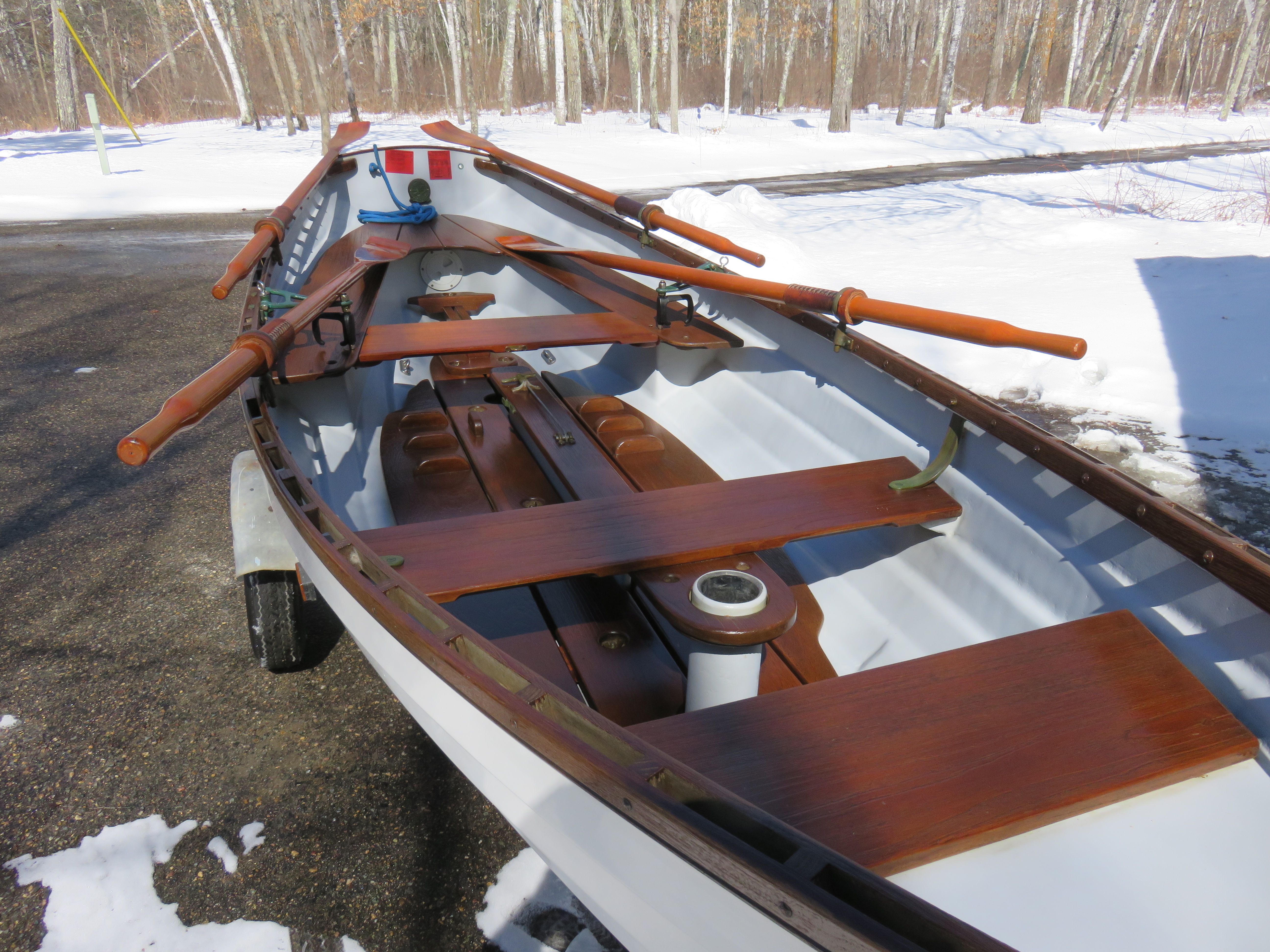 A 2005 Whitehall Spirit 14 rowing boat on a trailer in the snow.