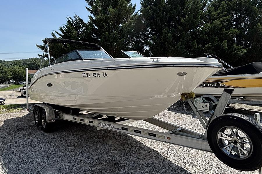 2019 Sea Ray SPX 230 Outboard boat on trailer, parked outdoors.