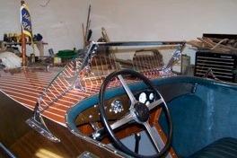 1931 Hacker-Craft 26 Dolphin boat interior with wooden dashboard and steering wheel.
