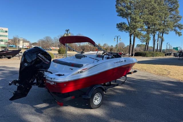 2026 Tahoe T16 boat with Mercury engine, parked outdoors on a sunny day.