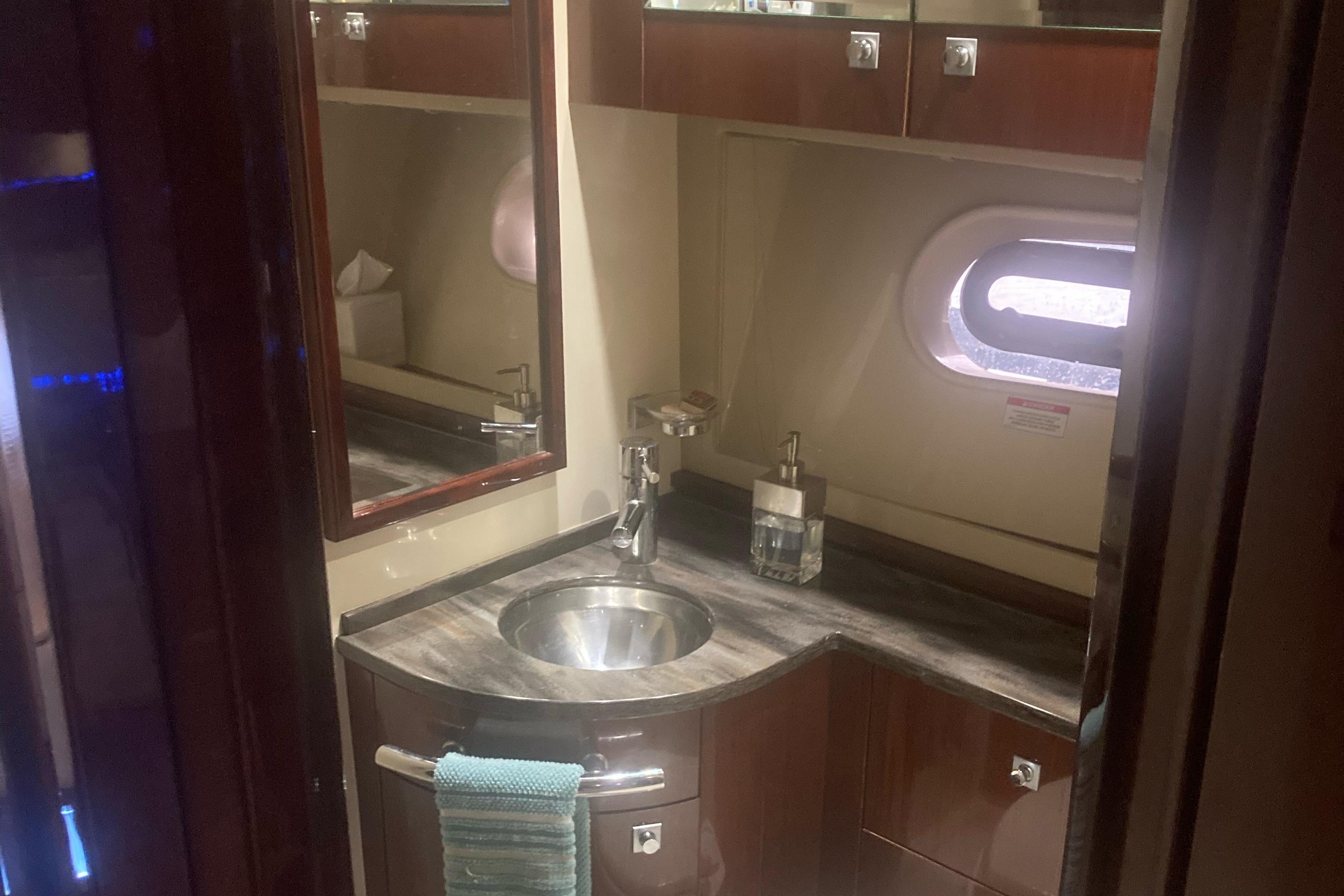 Luxurious bathroom interior of 2015 Sea Ray 450 Sundancer yacht with modern fixtures.