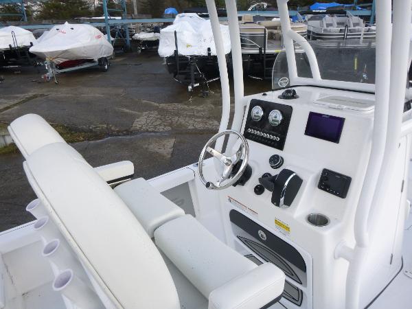 2025 Sea Pro 230 Bay boat interior with steering wheel and control panel.