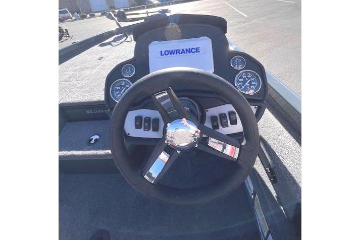 2026 Ranger RT188P boat dashboard with Lowrance display and steering wheel in parking lot.