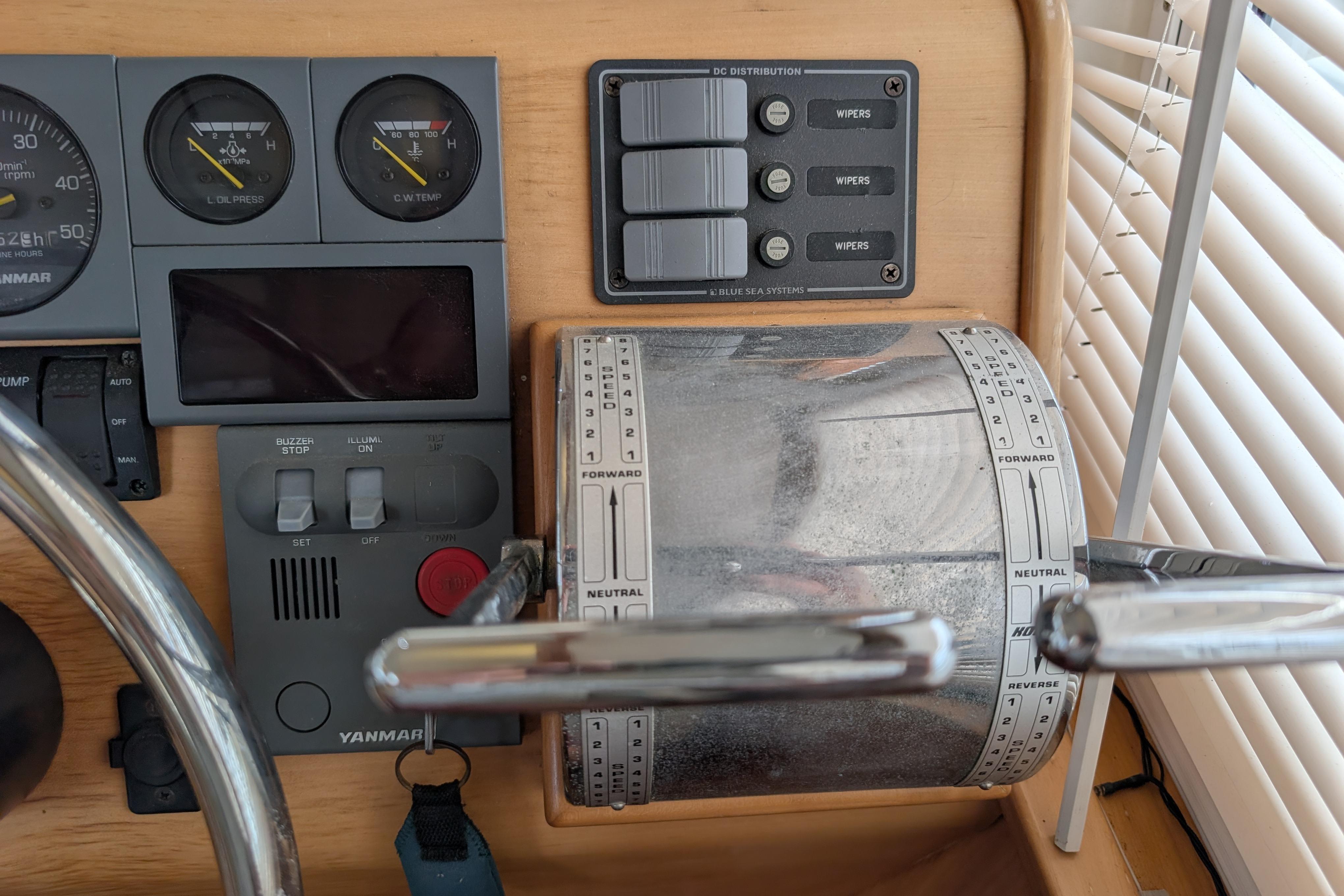 Control panel of a 2004 PDQ 34 Powercat boat with gauges and switches.