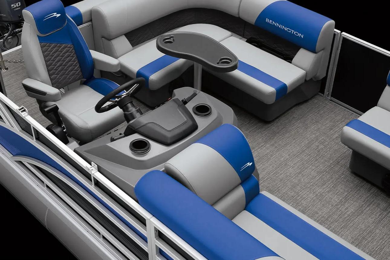 2026 Bennington S 20 SSR pontoon boat interior with blue and gray seating and steering console.