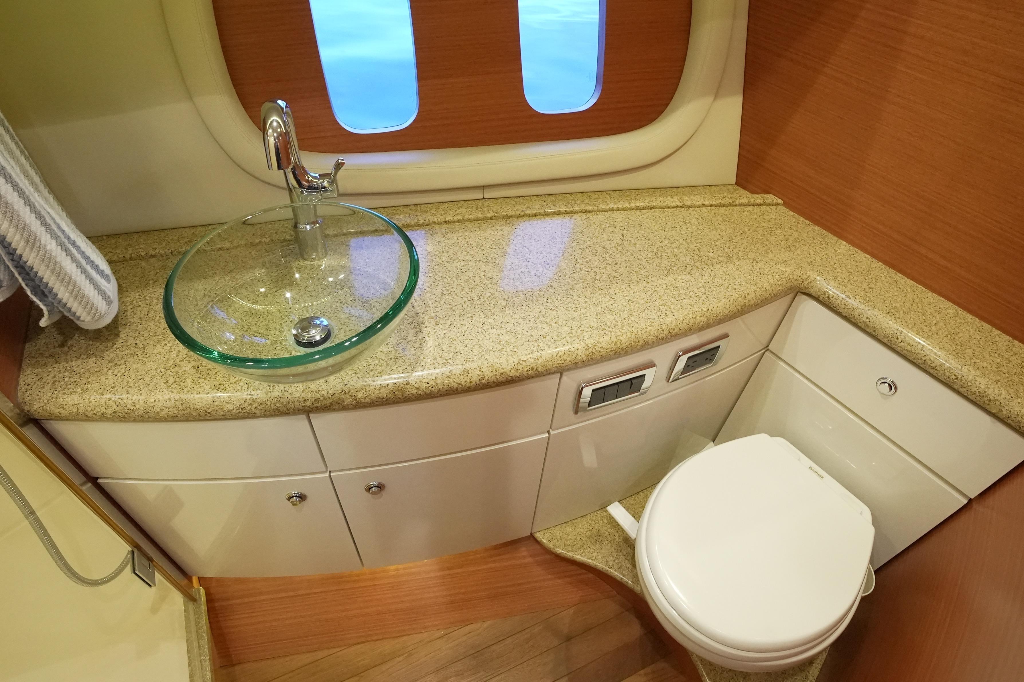 Luxurious bathroom in 2013 Zeelander Z44 yacht with glass sink and modern fixtures.