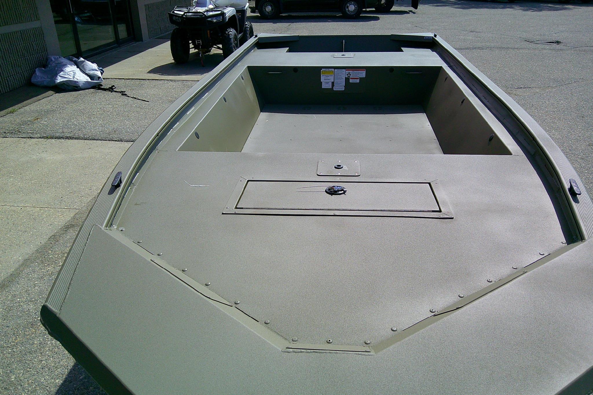 2026 Tracker Grizzly 1648 Utility boat, spacious deck, parked outdoors.