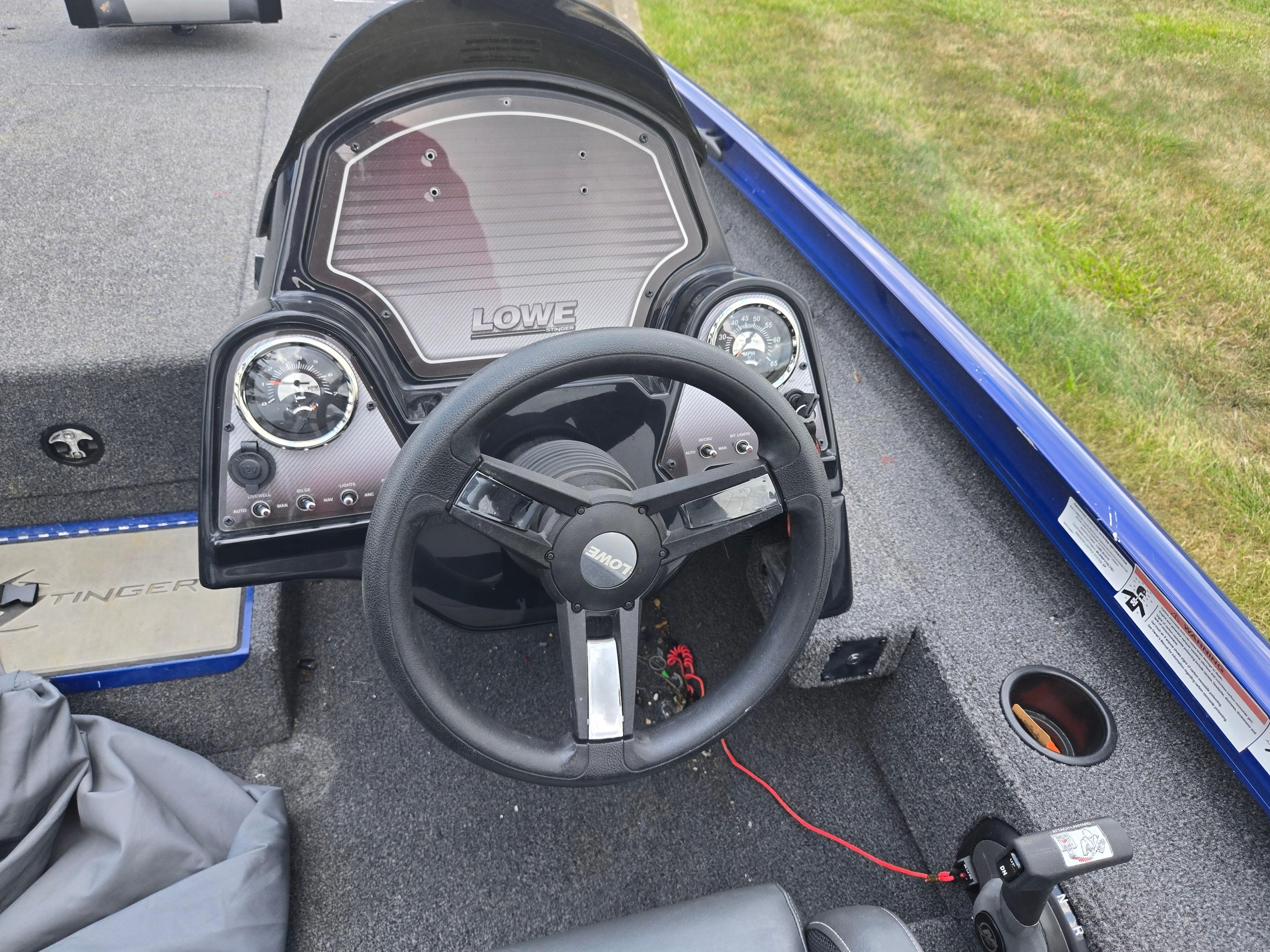 2021 Lowe Stinger 188 boat dashboard with steering wheel and gauges.