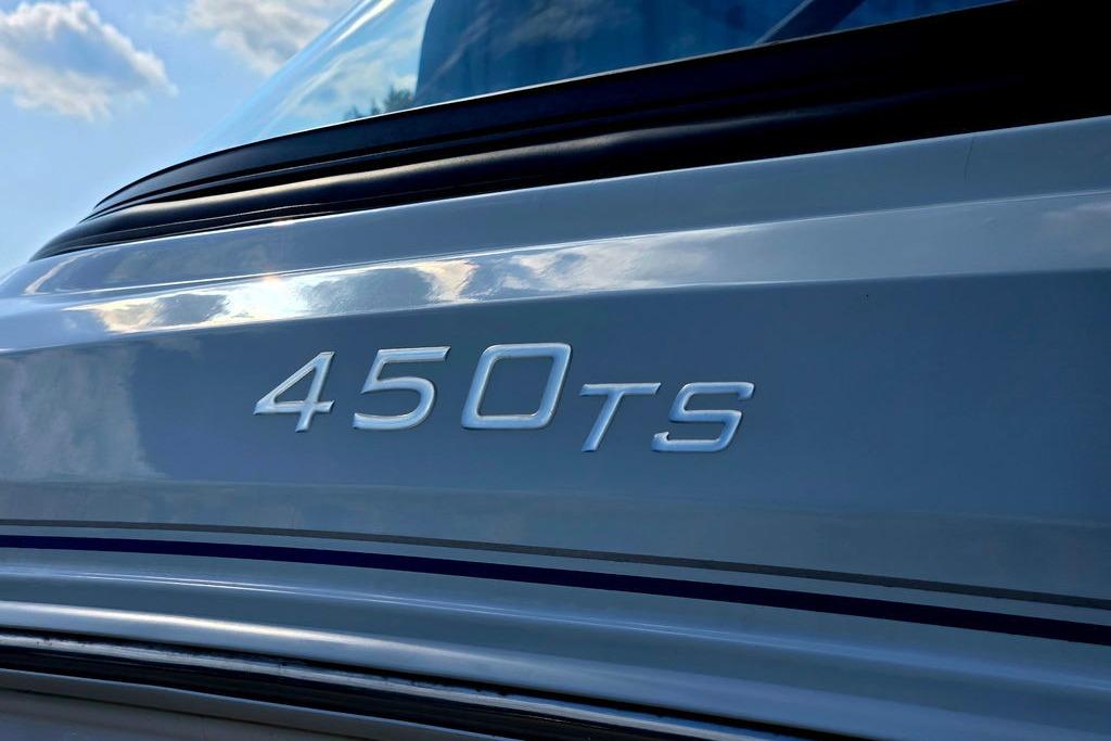 2018 Tahoe 450 TS boat model emblem with reflective surface under blue sky.