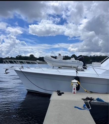 1986 Egg Harbor 60 Sportfisherman docked under a partly cloudy sky.