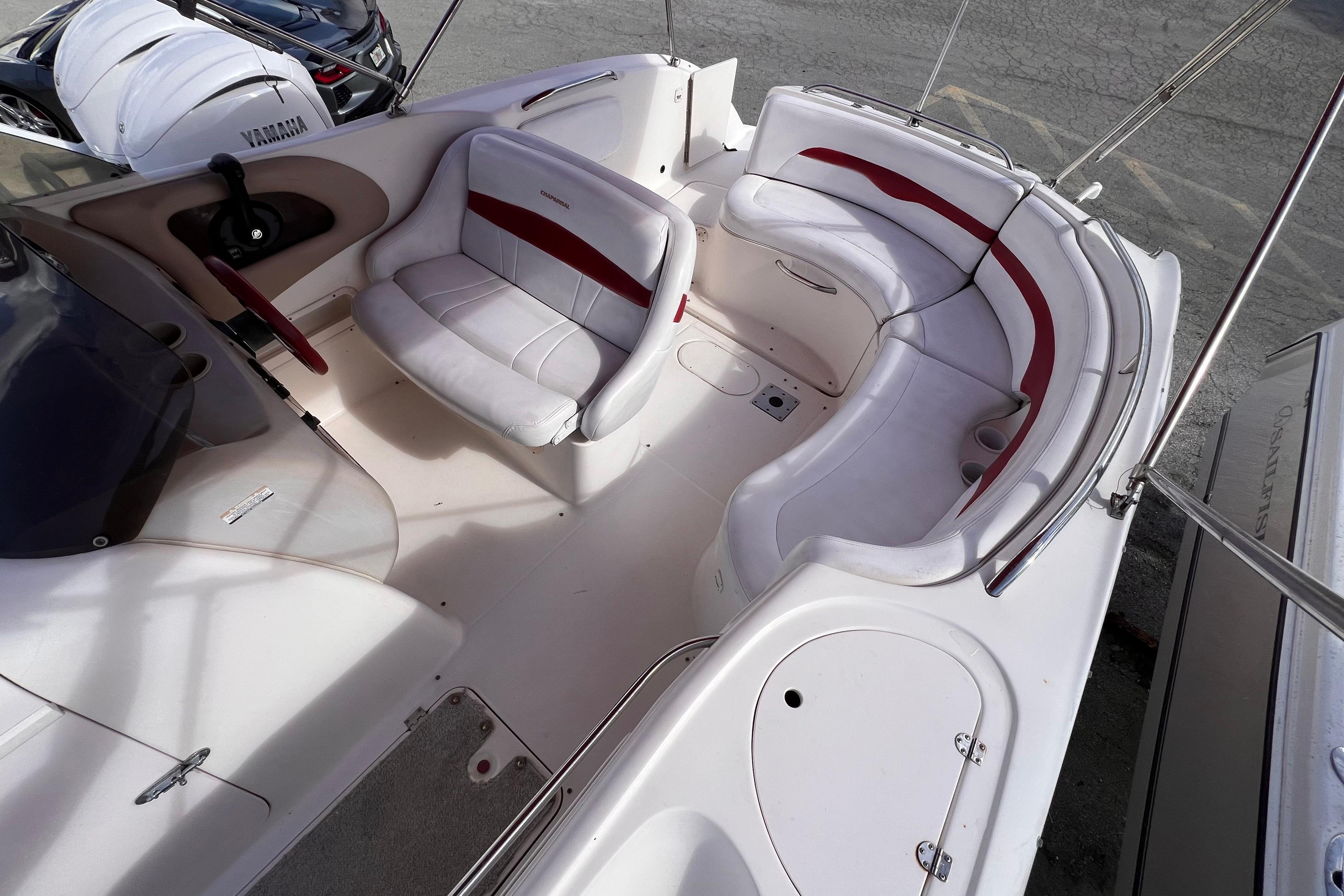 2002 Chaparral 232 Sunesta boat interior with white and red seating arrangement.