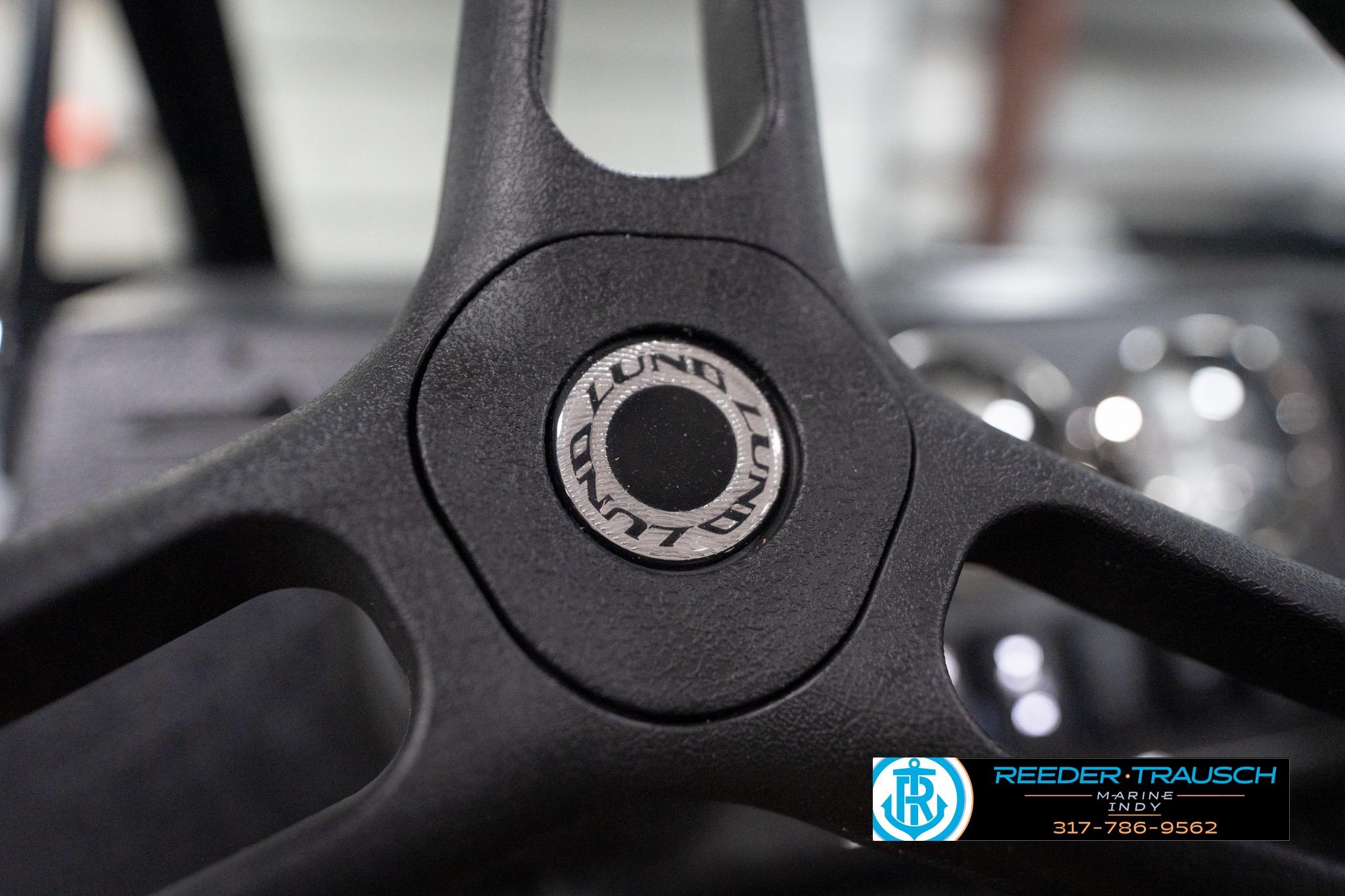 Close-up of 2026 Lund 1800 Explorer Sport steering wheel with logo.