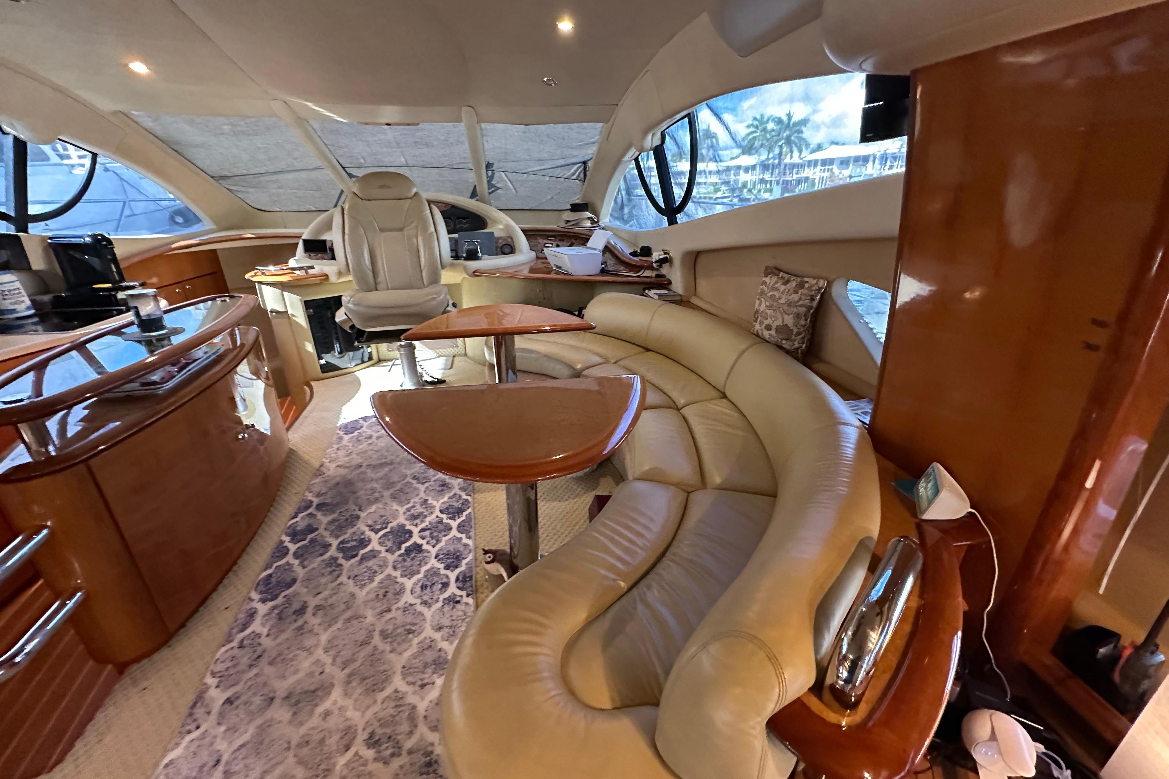 Luxurious interior of a 2004 Azimut 55E yacht with elegant seating and helm.