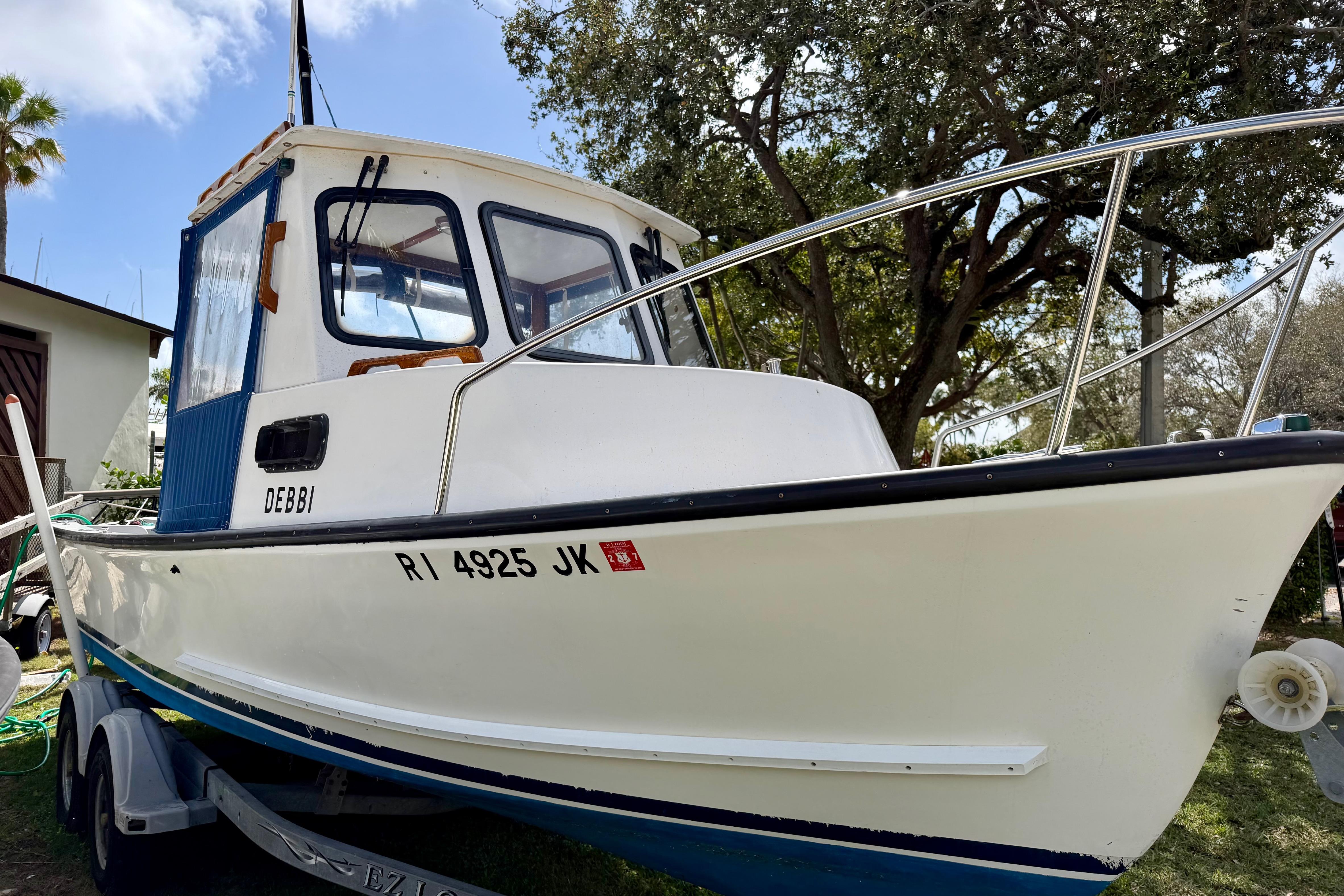 2000 Eastern 22 Lobster Fisherman boat on trailer, white hull, blue cabin, outdoors.