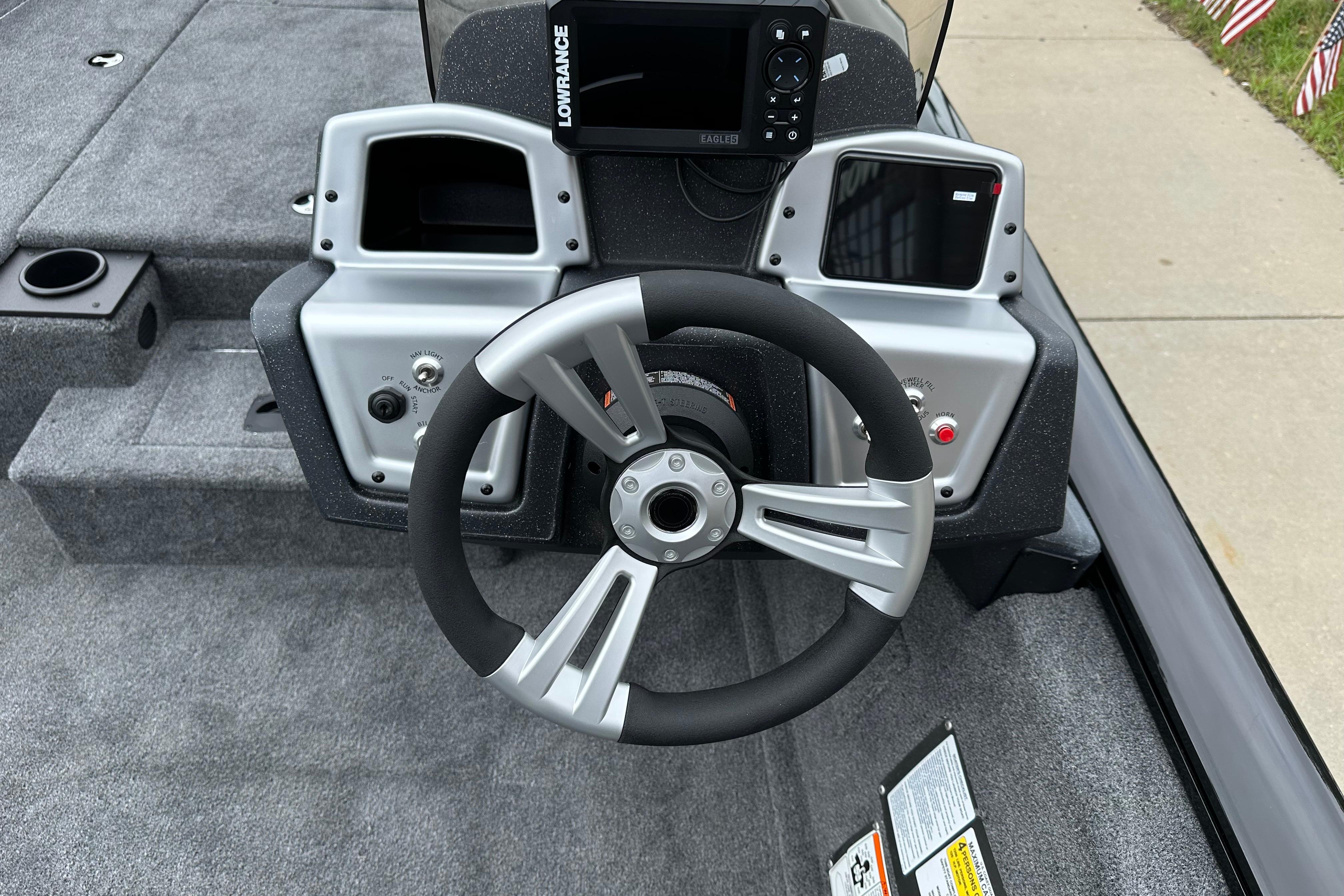 2026 Tracker Pro Team 190 boat dashboard with steering wheel and Lowrance display.