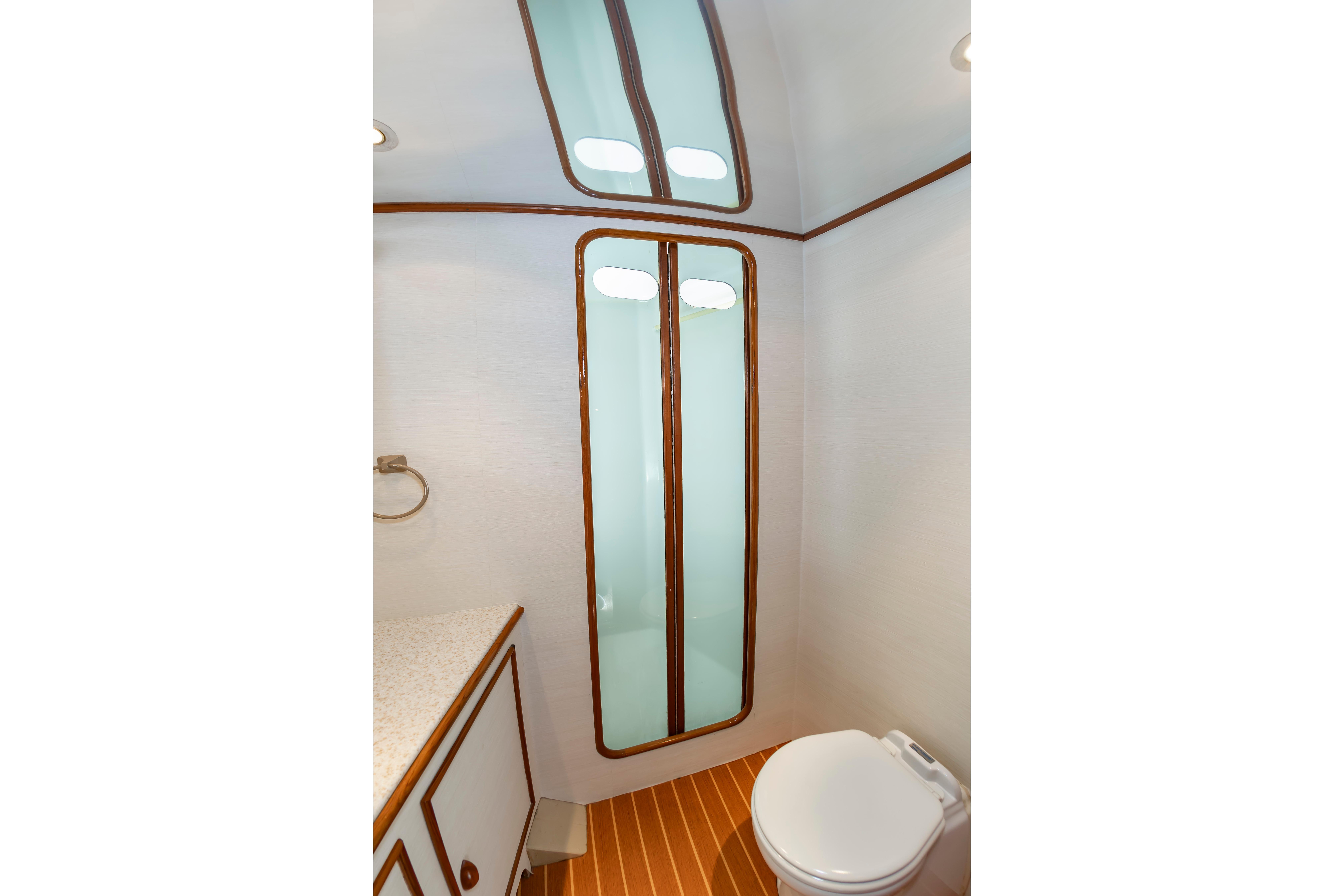 Bathroom interior of 1993 Custom Carolina Scarborough 56 Convertible yacht, featuring modern fixtures.