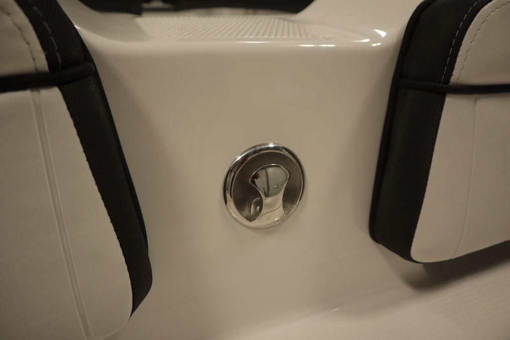 Yamaha Boats 2026 255 FSH Sport E interior detail with chrome fixture and cushioned seating.