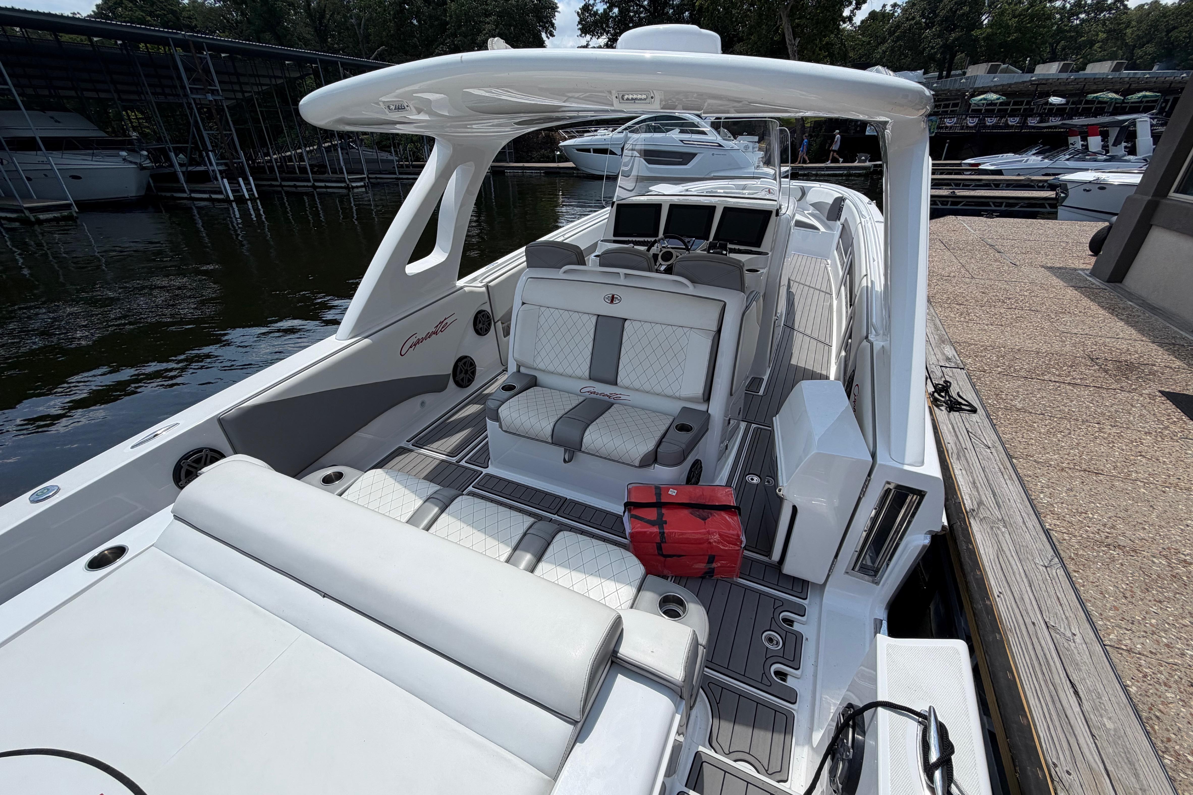 2015 Cigarette 41' Nighthawk SD Edition boat docked, featuring sleek white and gray interior.