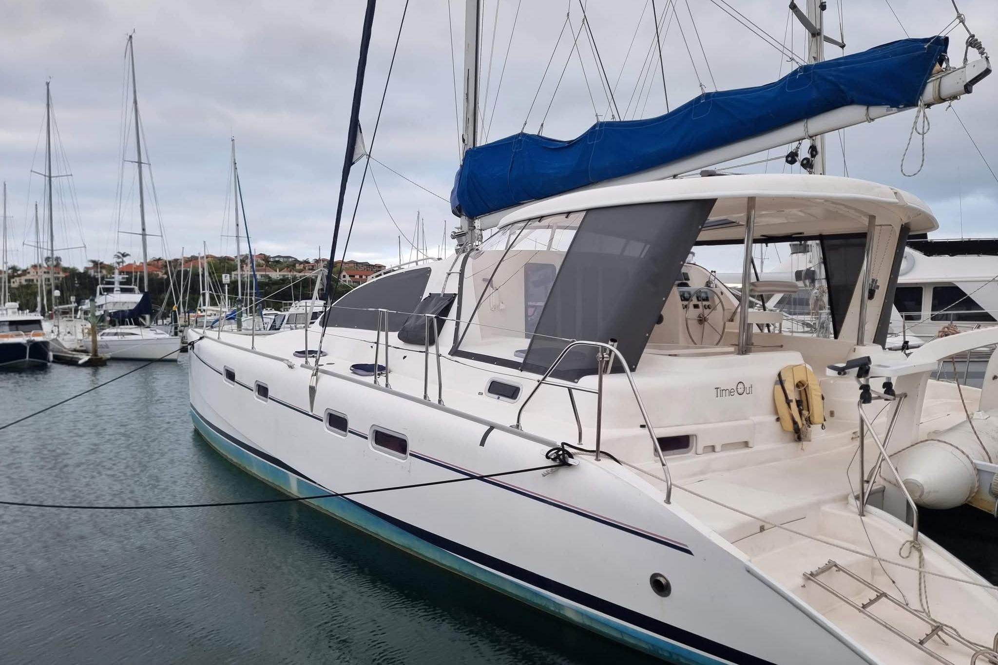2007 Leopard 43 catamaran docked in a marina, featuring a blue sail cover.