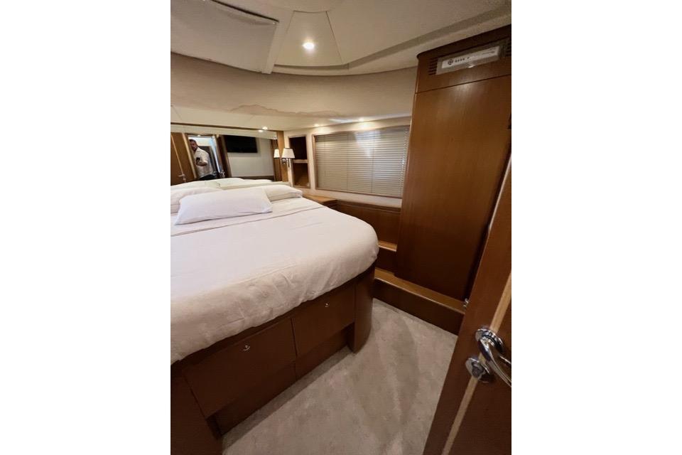 Luxurious cabin interior of 2008 Apreamare Maestro 65 yacht, featuring a cozy bed and wooden finishes.