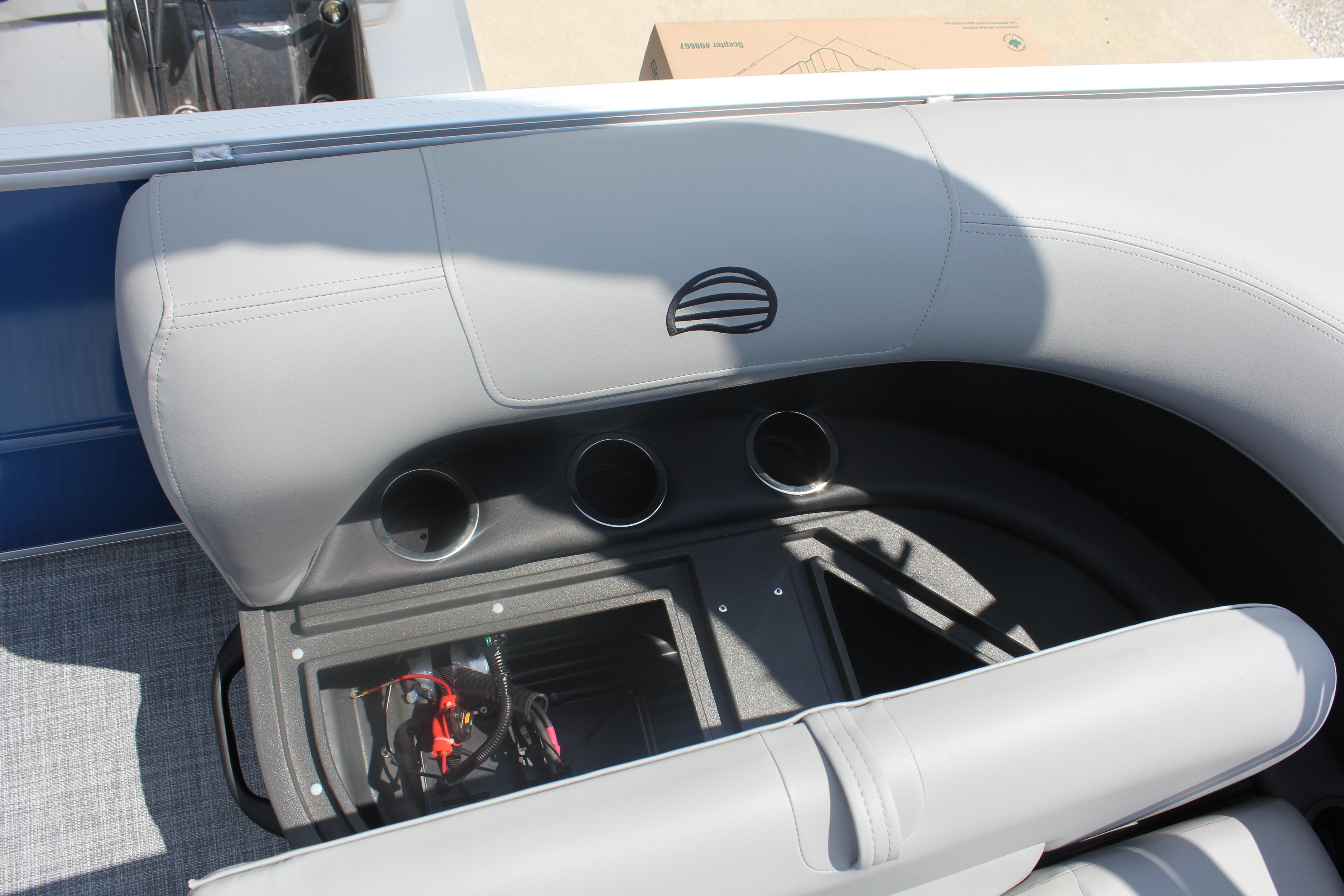 2026 Sun Tracker Party Barge 16 DLX interior with cup holders and storage compartment.
