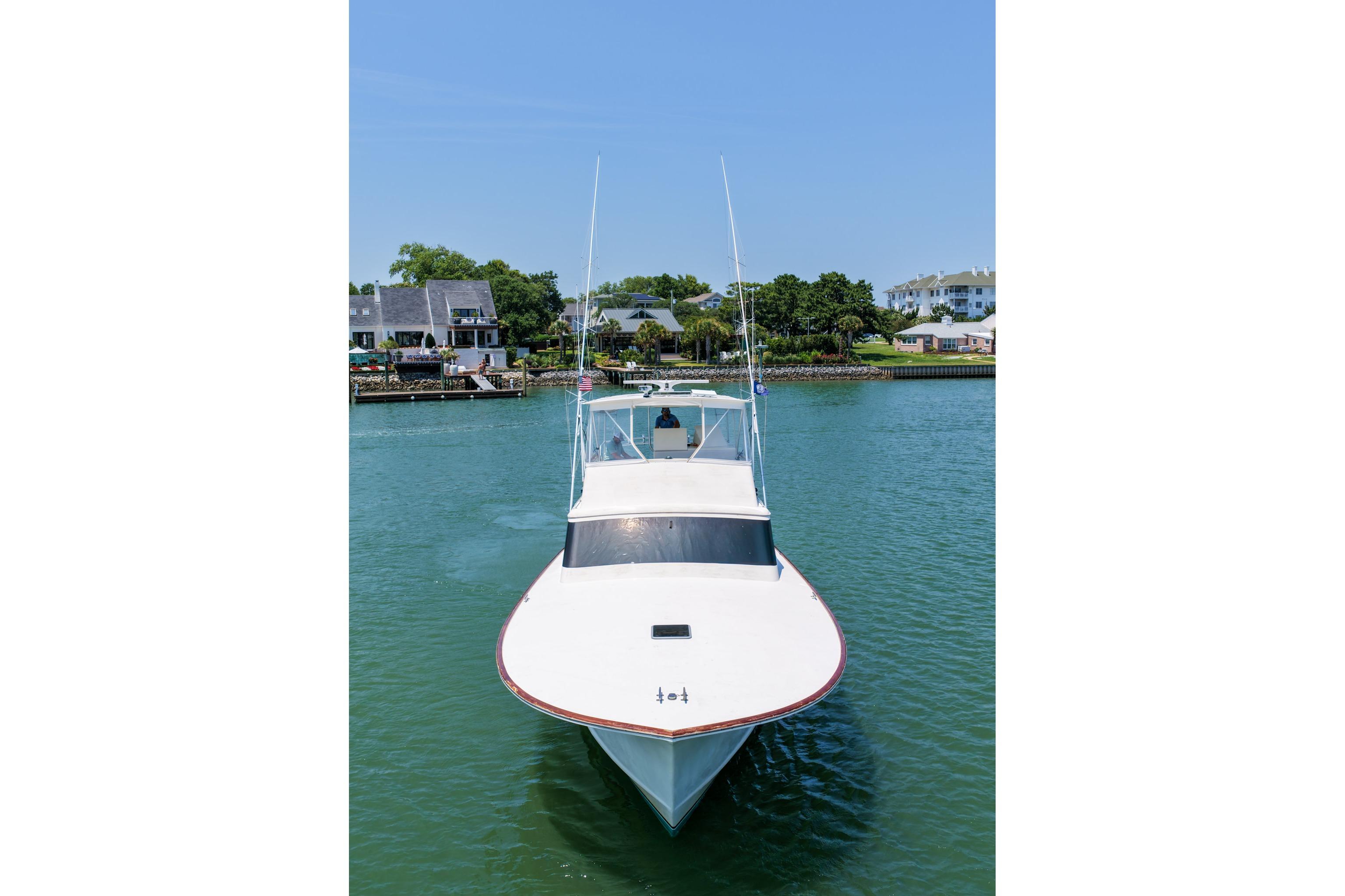 1998 Blackwell Custom Carolina Sportfish boat on calm water near residential area.