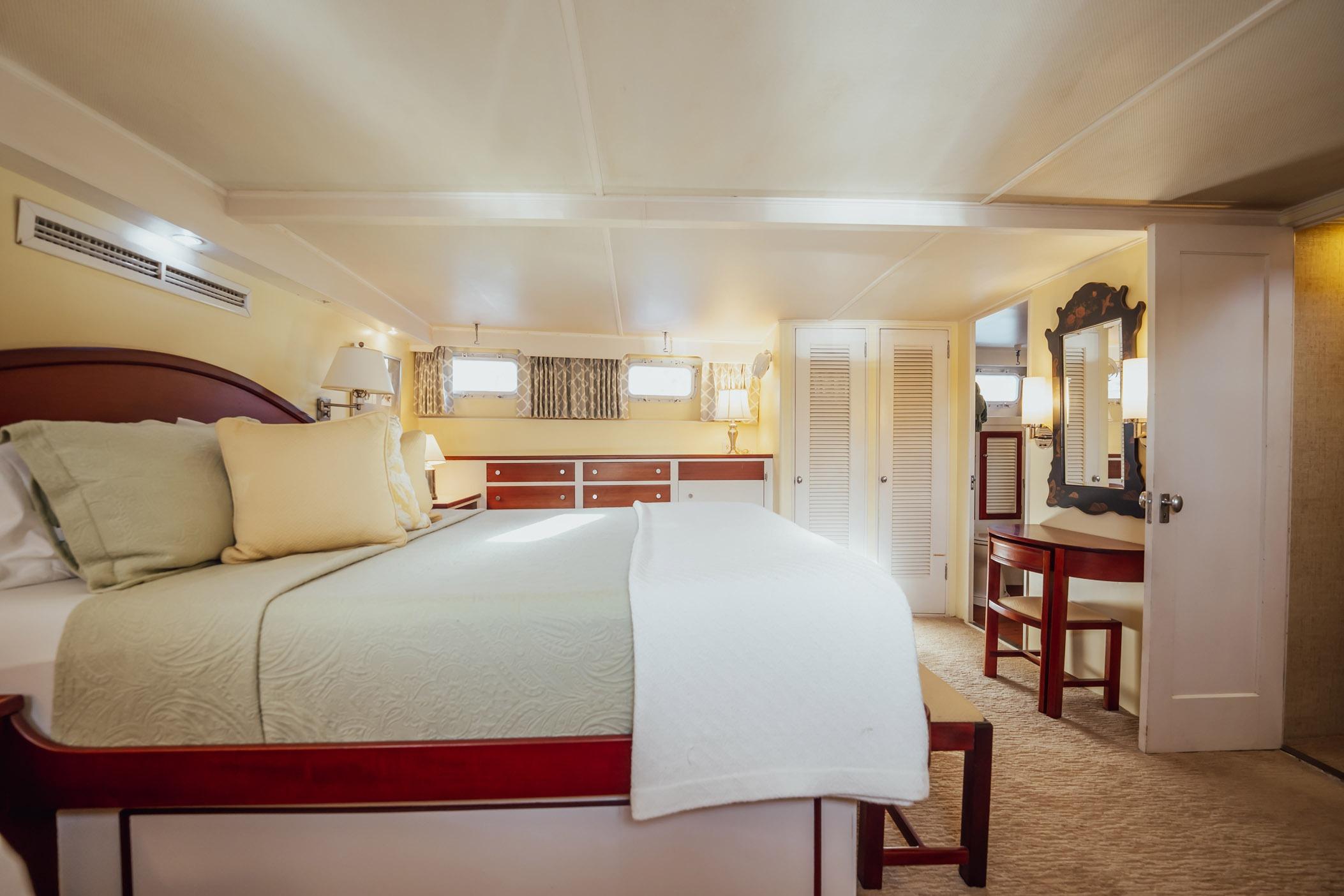 Luxurious bedroom interior on a 1972 Trumpy 72 Motor Yacht, featuring elegant furnishings.