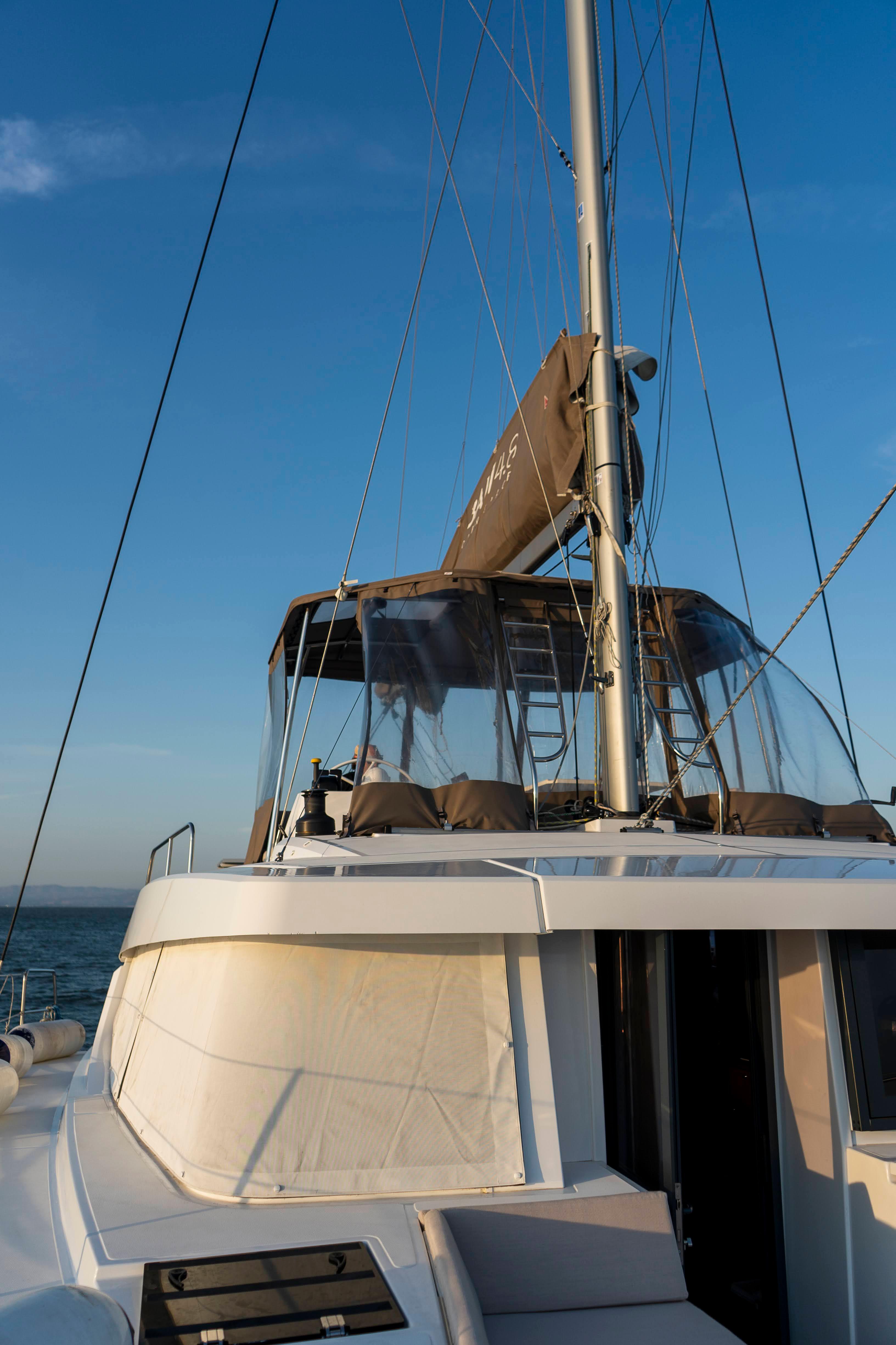 2021 Bali 4.8 catamaran sailing on open sea under clear blue sky.