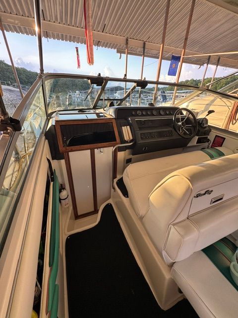 The cockpit of a 1992 Sea Ray 290 Sundancer with beige seats and a helm station.