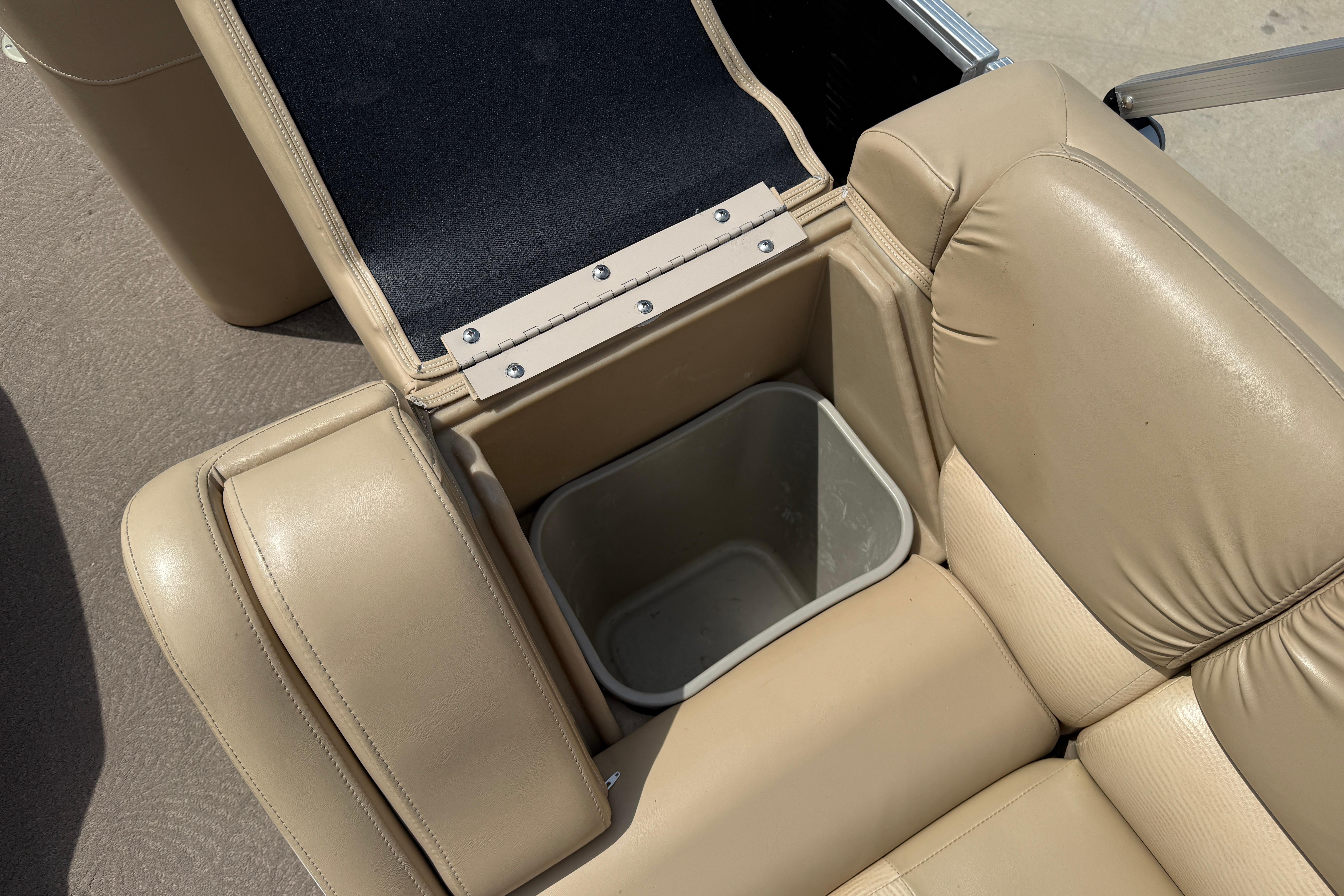 2011 Bennington 2575QCW I/O boat seat with built-in storage compartment.
