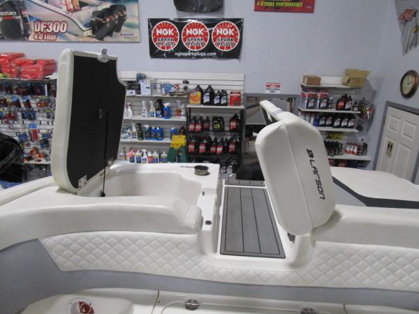 2017 Larson 292 LXI boat interior with open storage, in a marine supply store.
