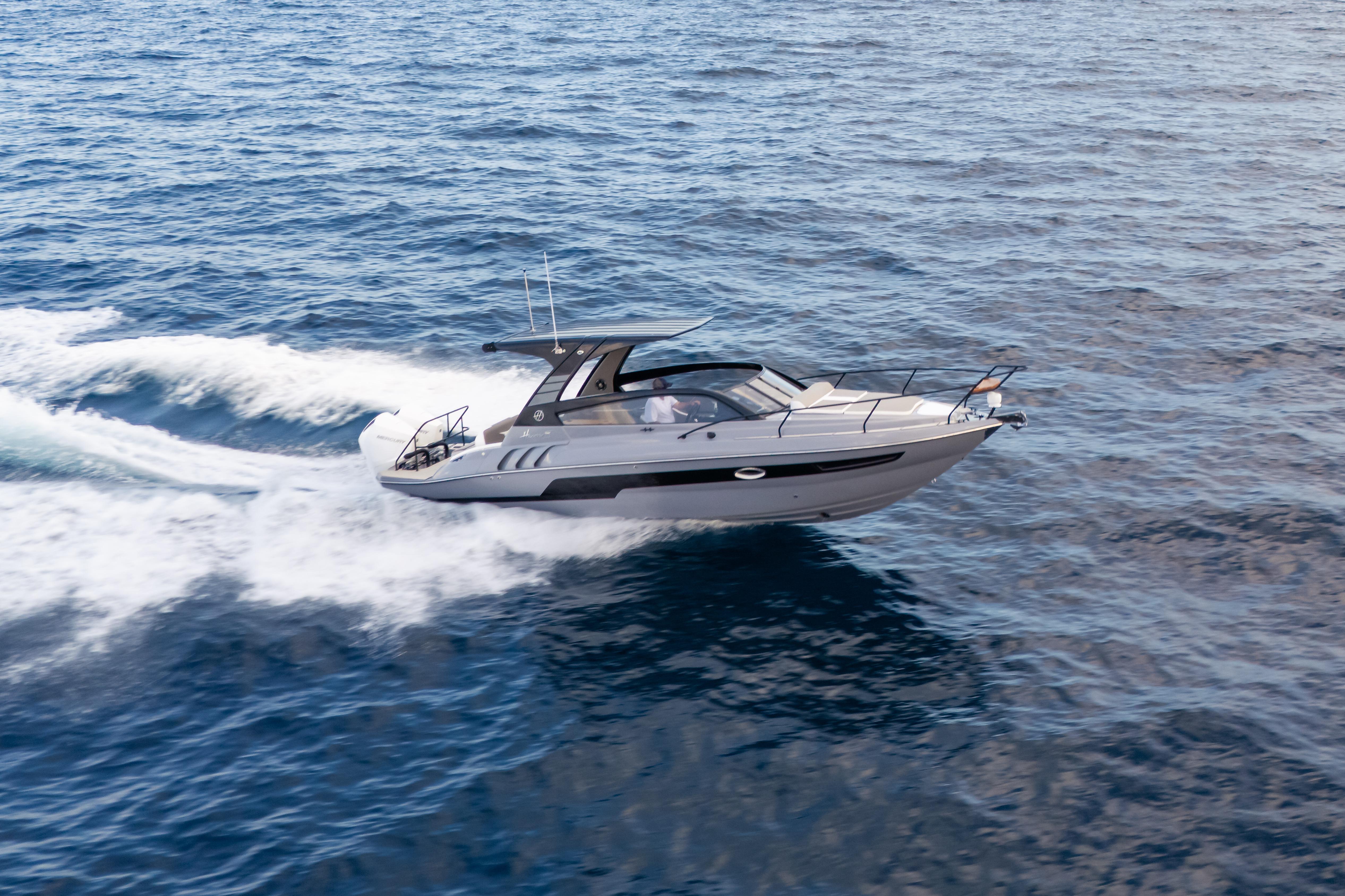 2026 Hanover 305 yacht cruising on open sea, showcasing sleek design and performance.