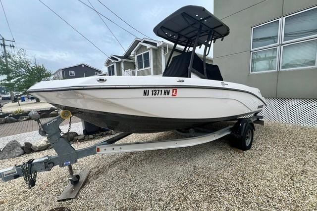 2019 Yamaha Boats 190 FSH Sport on trailer, parked outdoors near residential area.
