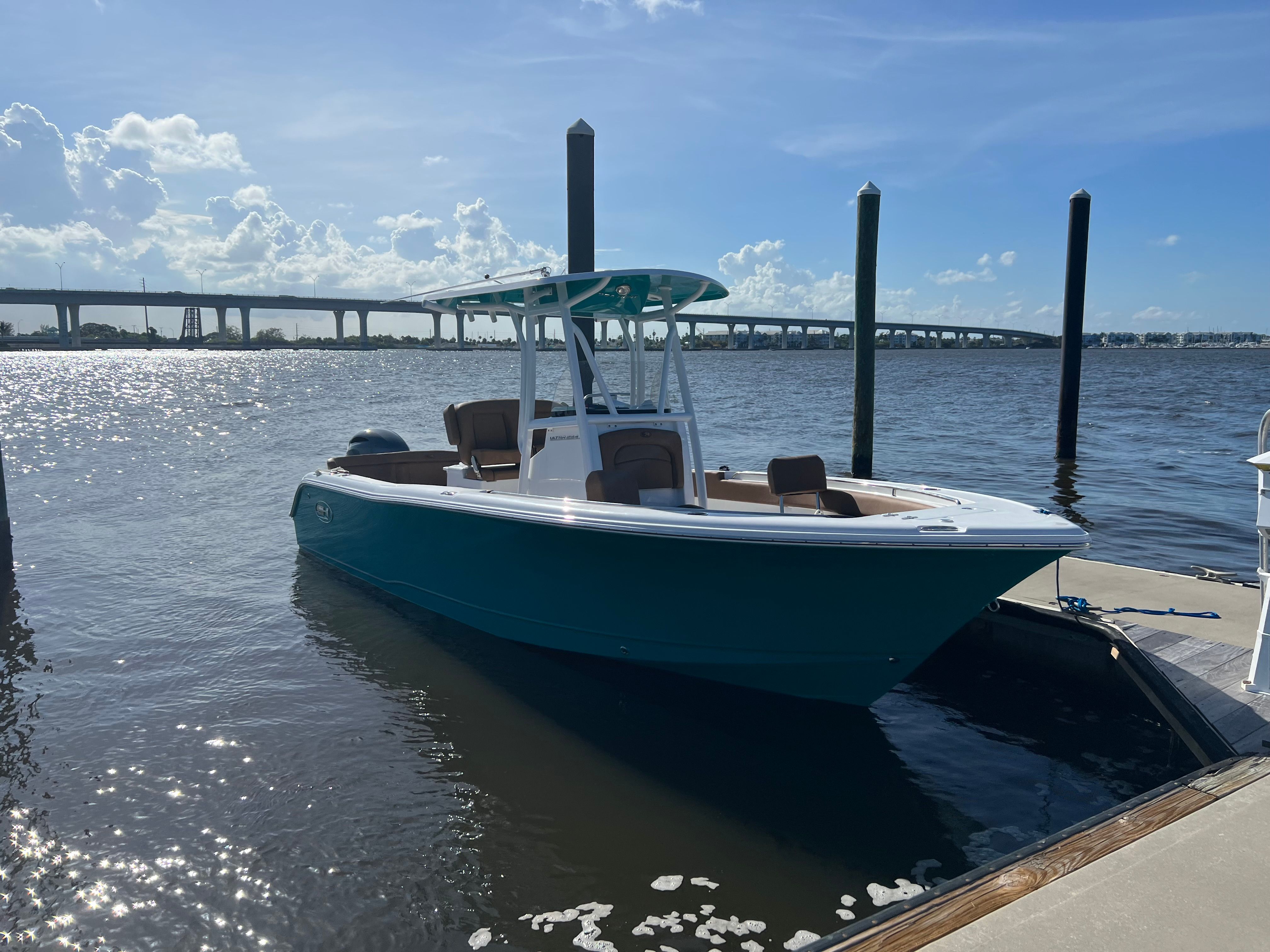 2022 Sea Hunt Ultra 234 boat docked on a sunny day.