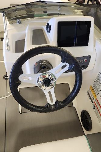 Steering wheel and dashboard of 2025 Tahoe T16 boat, featuring modern controls and display.