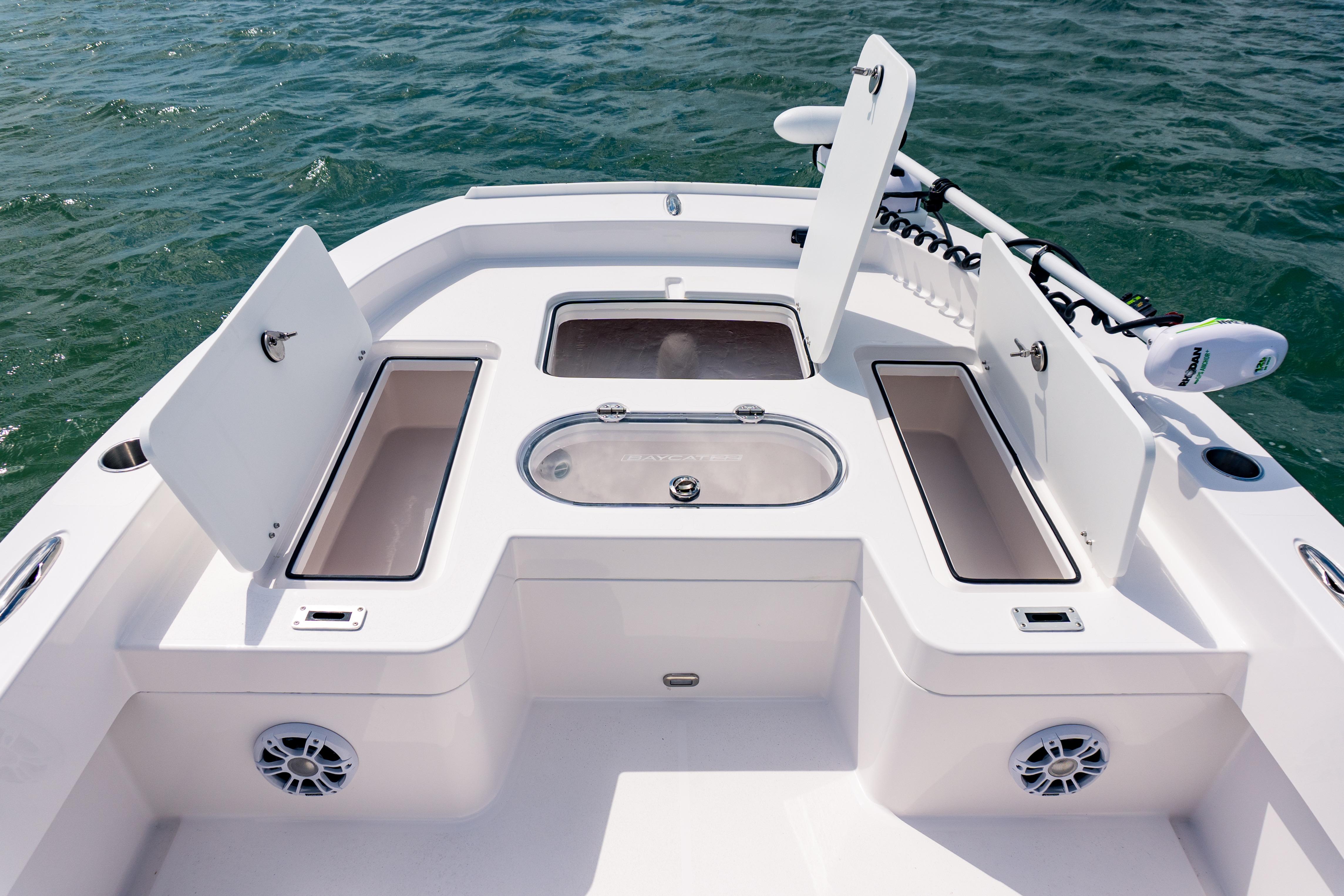 2026 Twin Vee 22 BayCat boat deck with storage compartments and trolling motor on water.