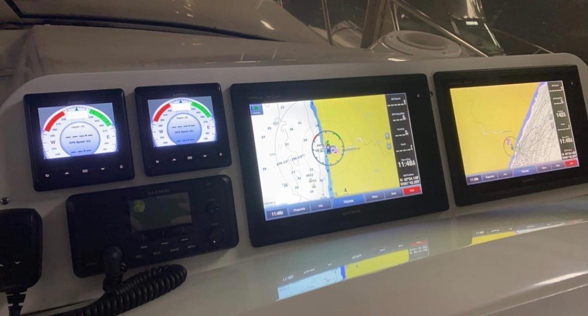 Dashboard of 2004 Fountain 48 Express Cruiser with navigation and control displays.