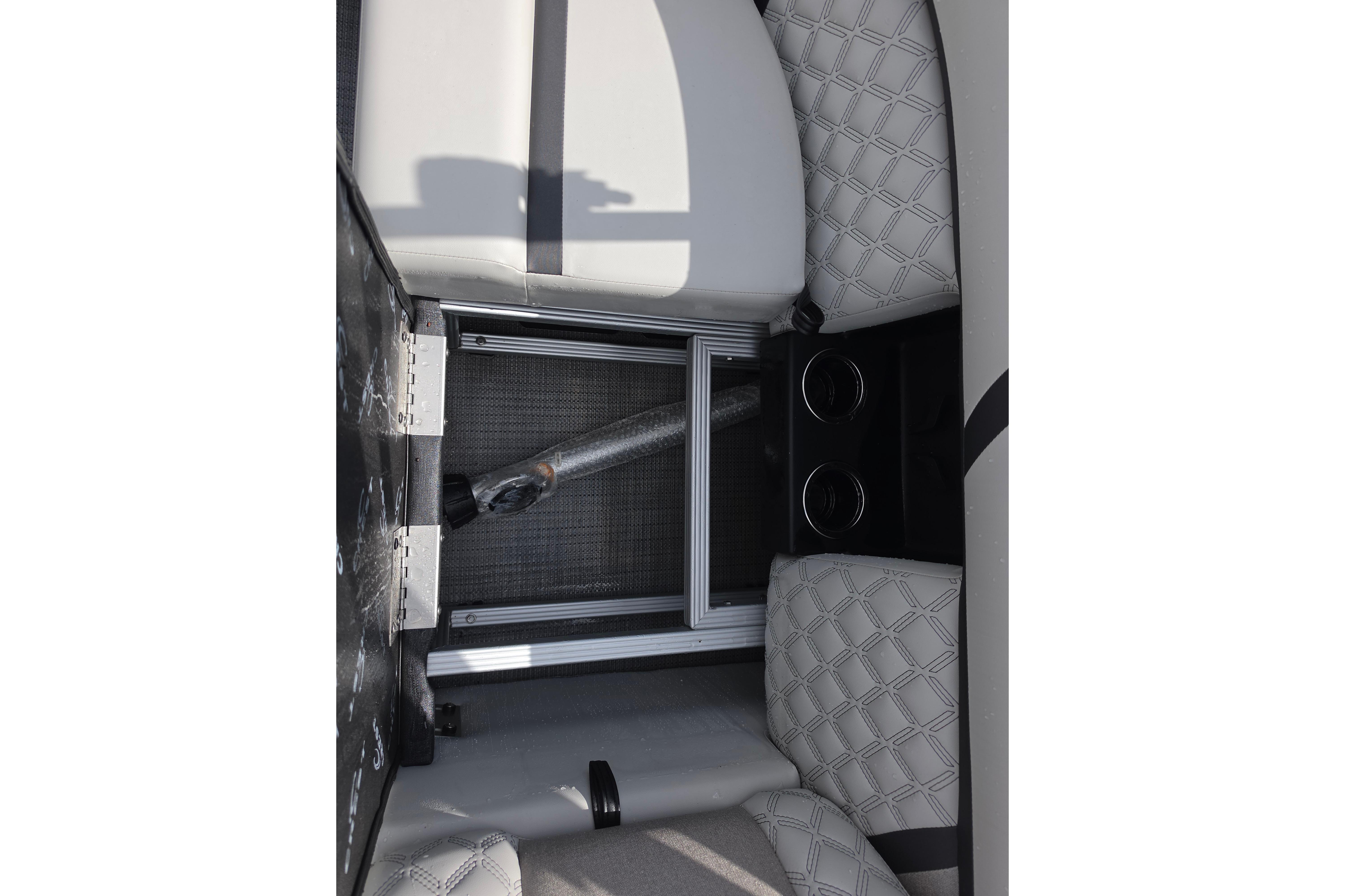 Interior view of 2026 Crest 235 Conquest SLC boat with quilted seating and storage compartment.
