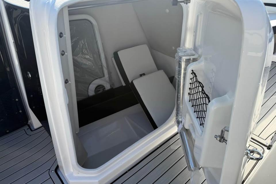 2026 Yamaha Boats 252S storage compartment with open door and interior view.