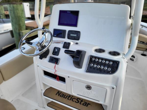 2021 NauticStar 2302 Legacy boat console with steering wheel, controls, and navigation equipment.