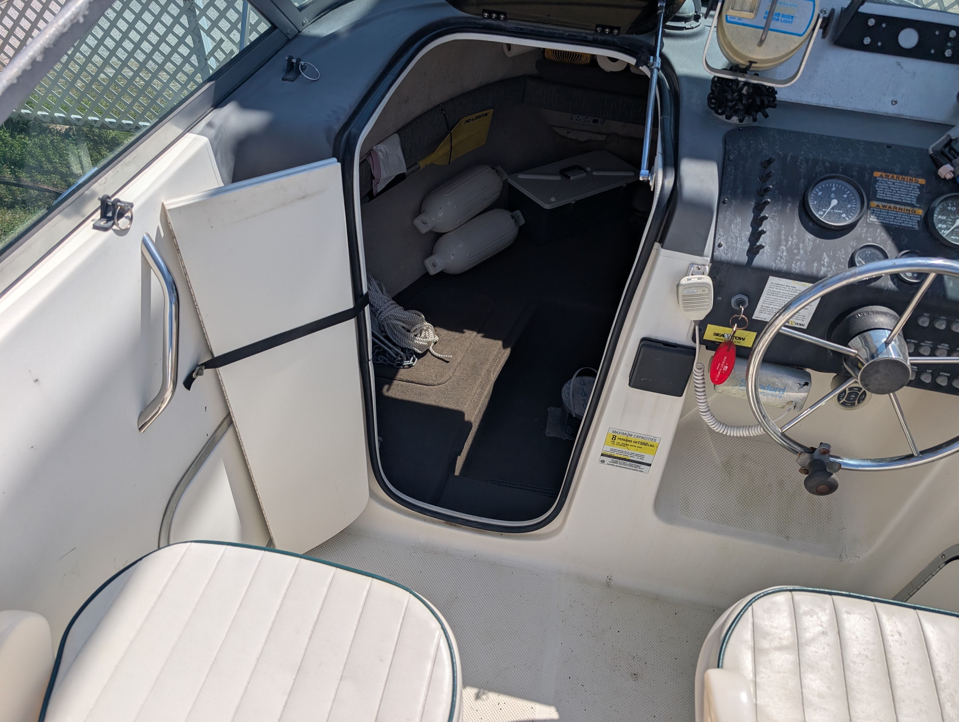The image shows the cockpit of a 2001 Trophy Bayliner boat with steering and instruments.