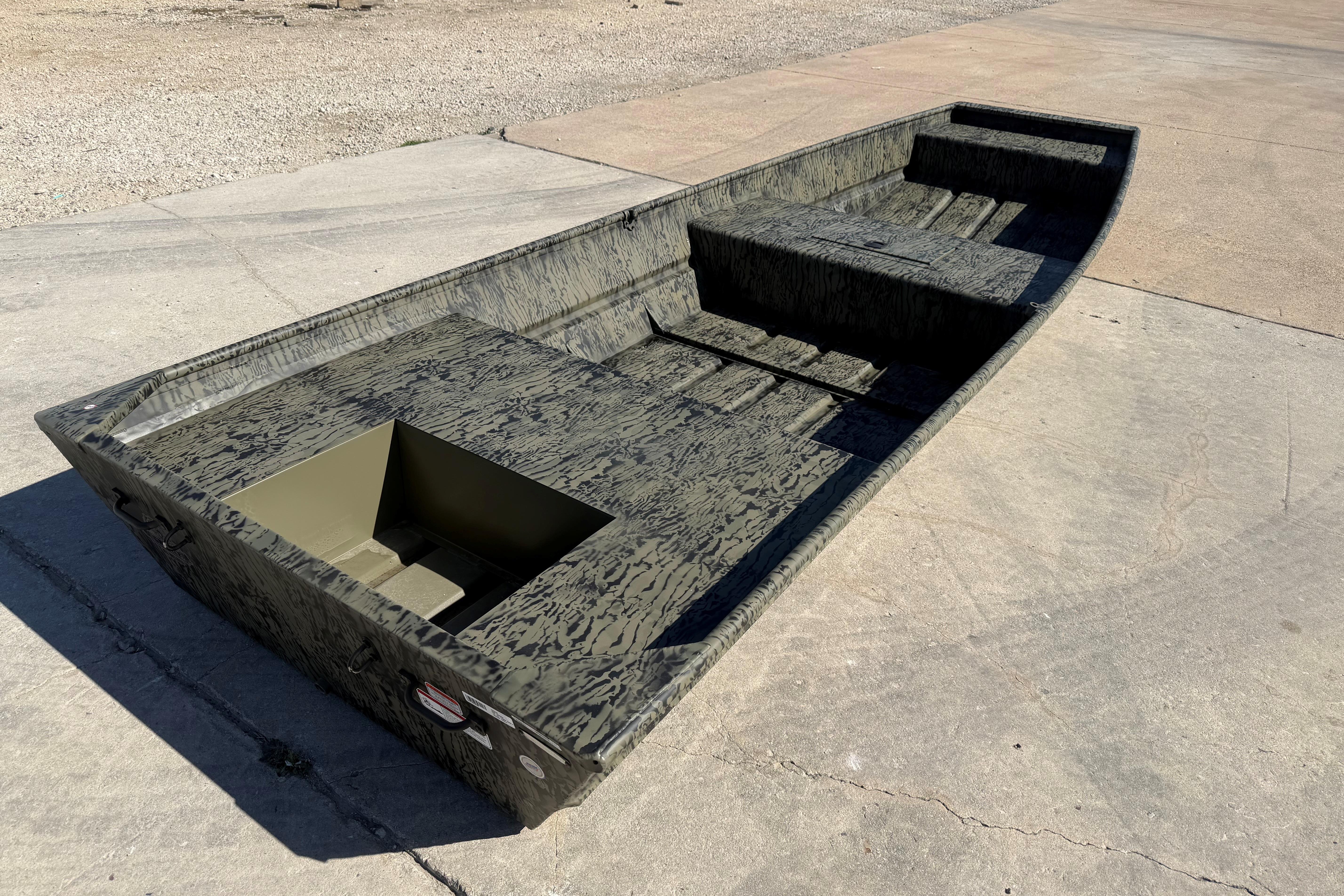 2026 Tracker Grizzly 15 Jon boat on concrete surface, showcasing rugged design and spacious interior.