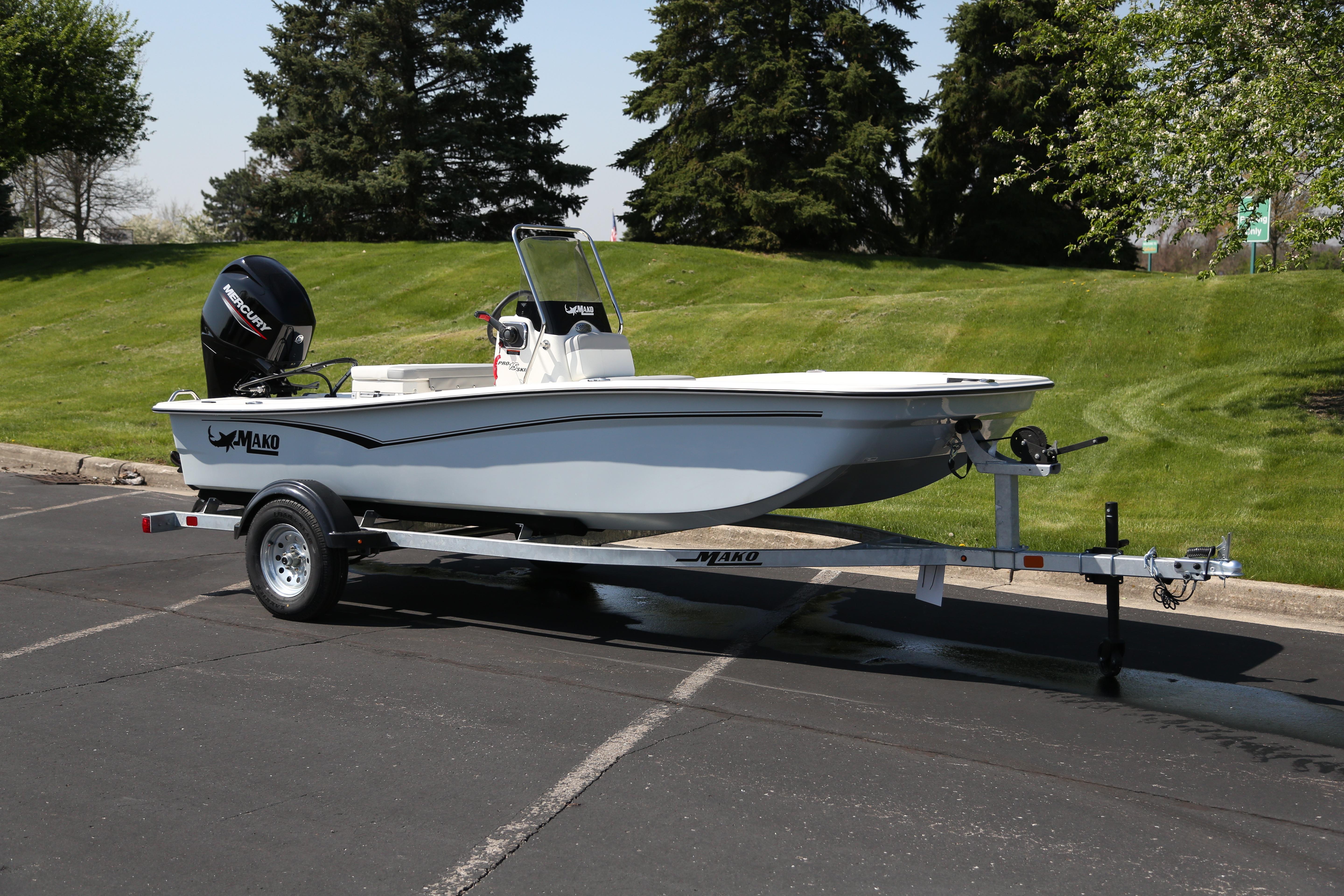 2026 Mako Pro Skiff 15 CC boat on trailer, parked outdoors with green grass background.