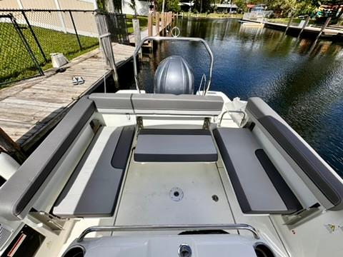 2023 Jeanneau Leader 7.5 CC Series 3 boat with spacious seating by the water.