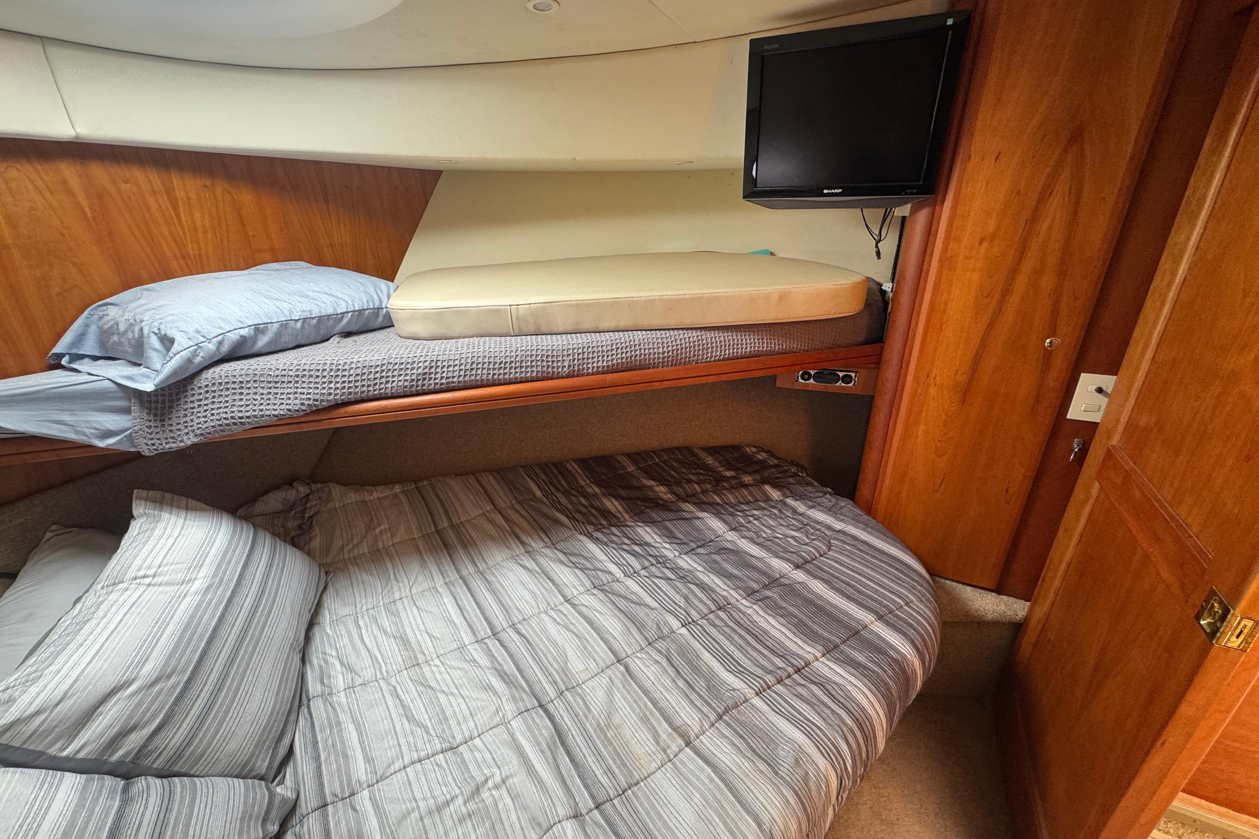 2003 Silverton 39 Motor Yacht cabin with bunk beds and wall-mounted TV.